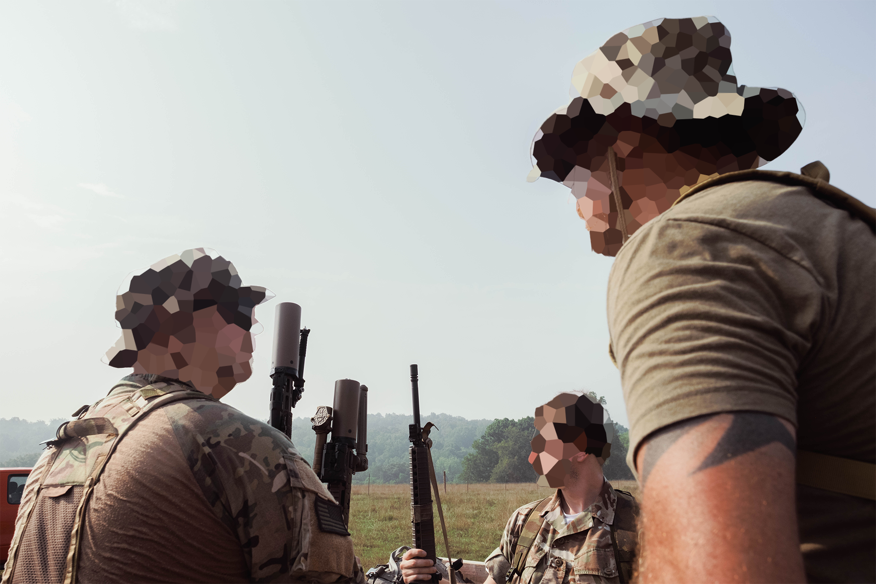 Militiamen in the bed of a truck driving through the training ground. July 18, 2026.