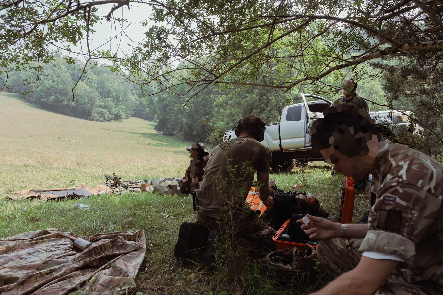 Members of the militia rest in the heat after shooting. July 18, 2026.