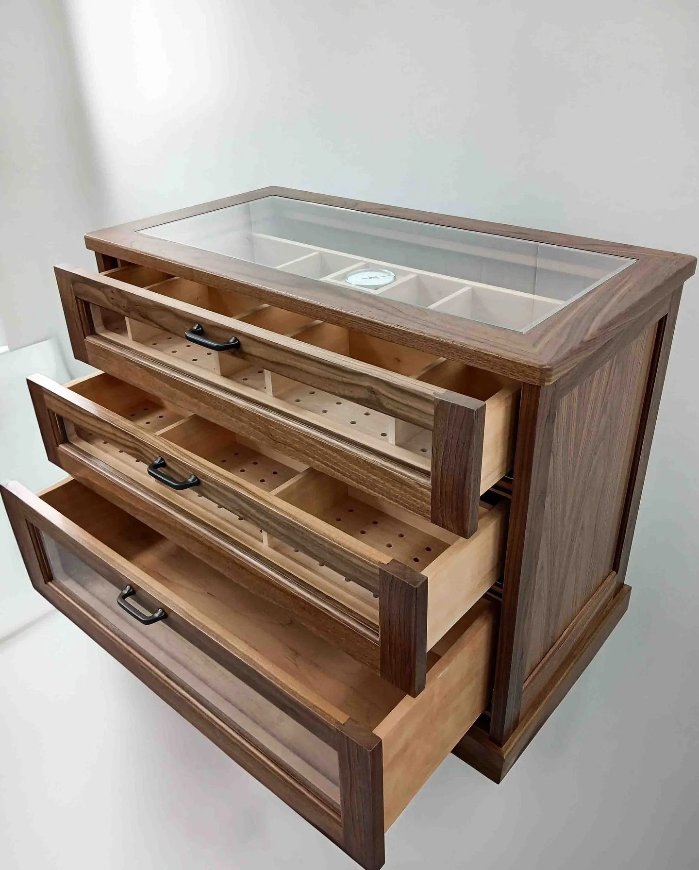 Have a cigar- or as many as you please from your custom humidor! 

This hand made piece features Spanish cedar interiors with a built in hygrometer, hidden Bluetooth climate controls &amp; ventilated drawers. All housed in a walnut exterior with clea