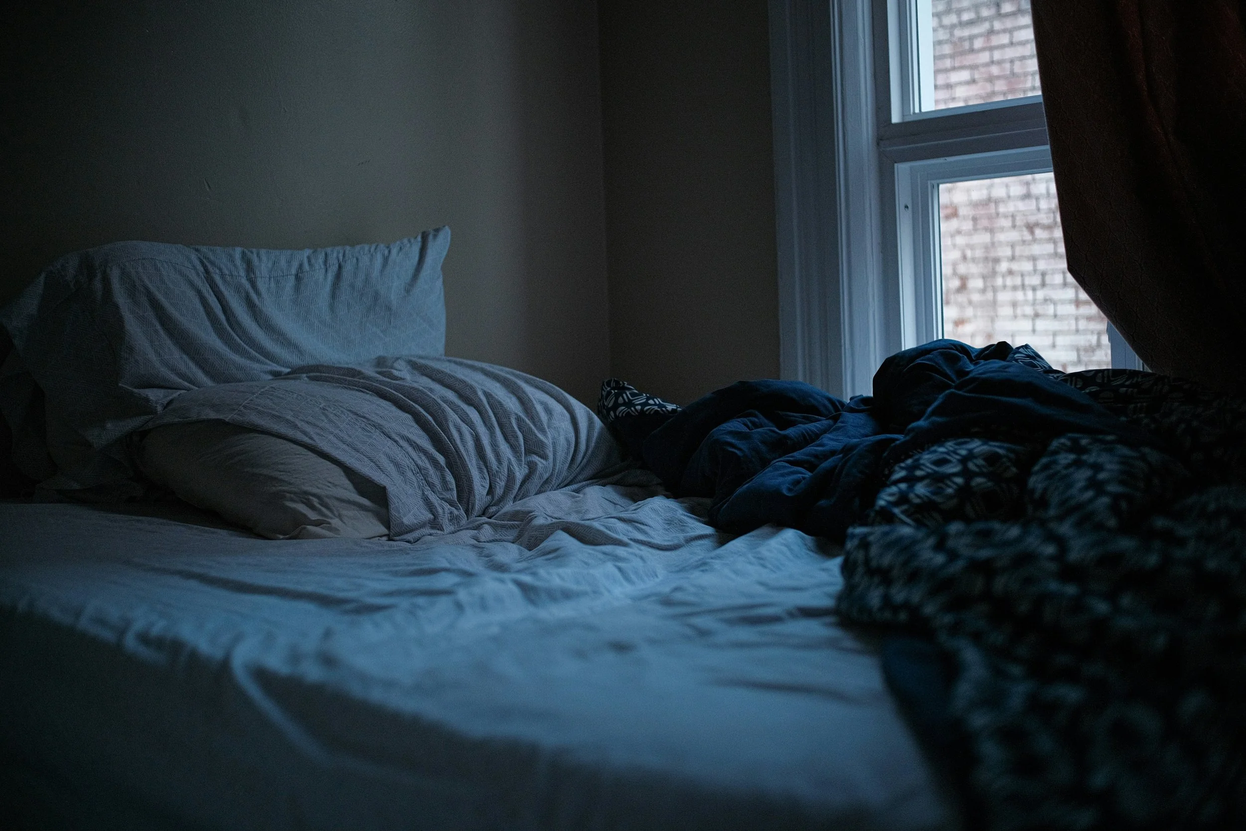 bed of college student experiencing holiday regression syndrome over winter break