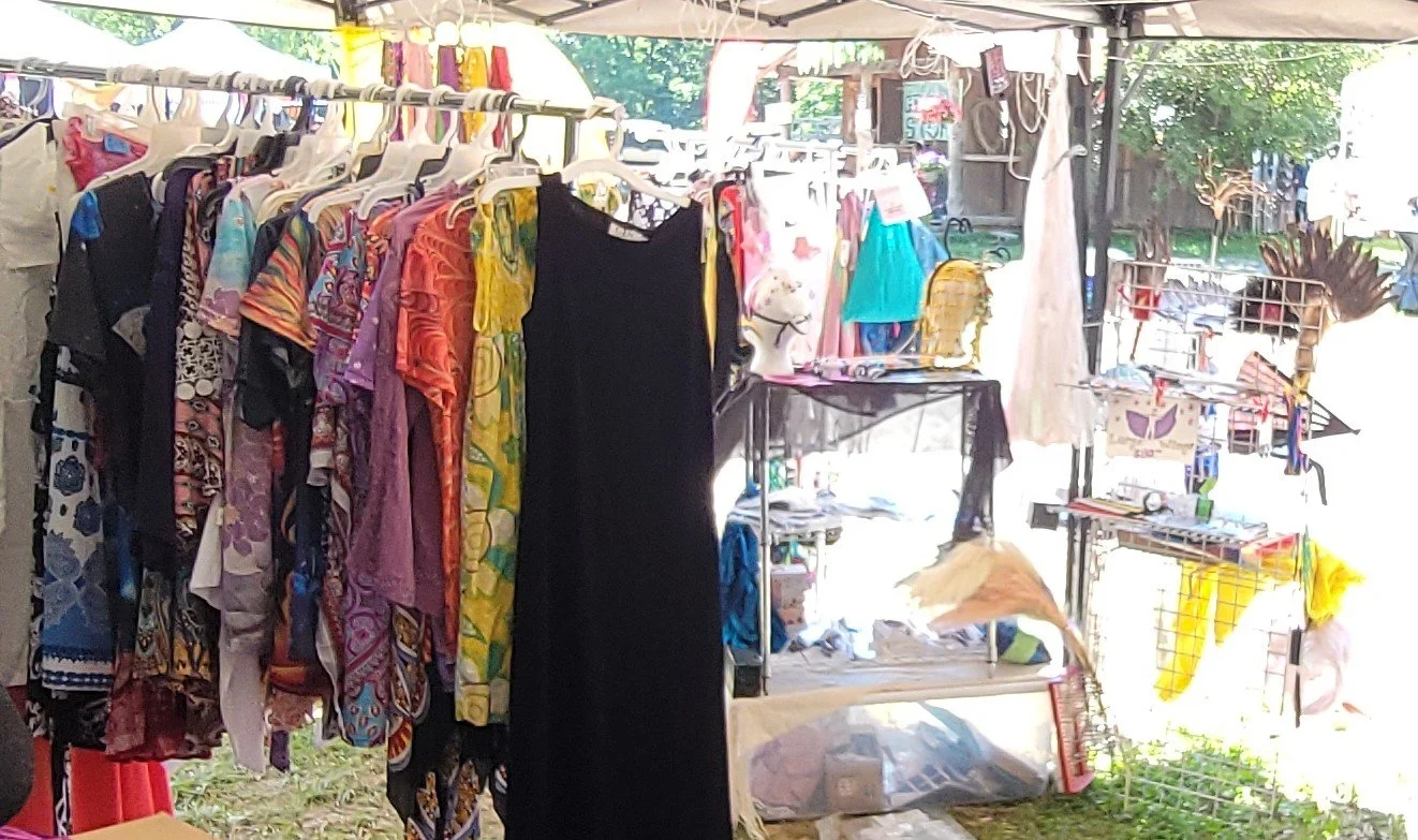 Clothing, fans, and accessories in the Scarbrough Fair Traders booth.