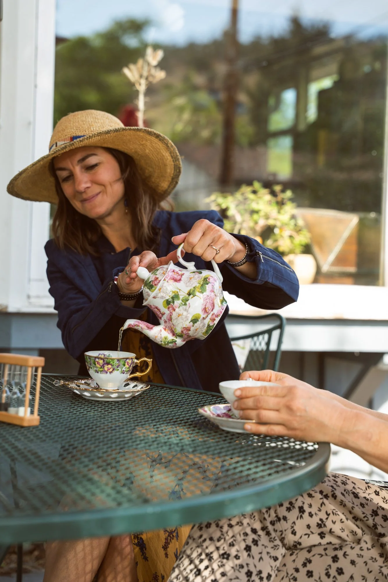 Customers enjoying a custom tea blend on the shaded patio.