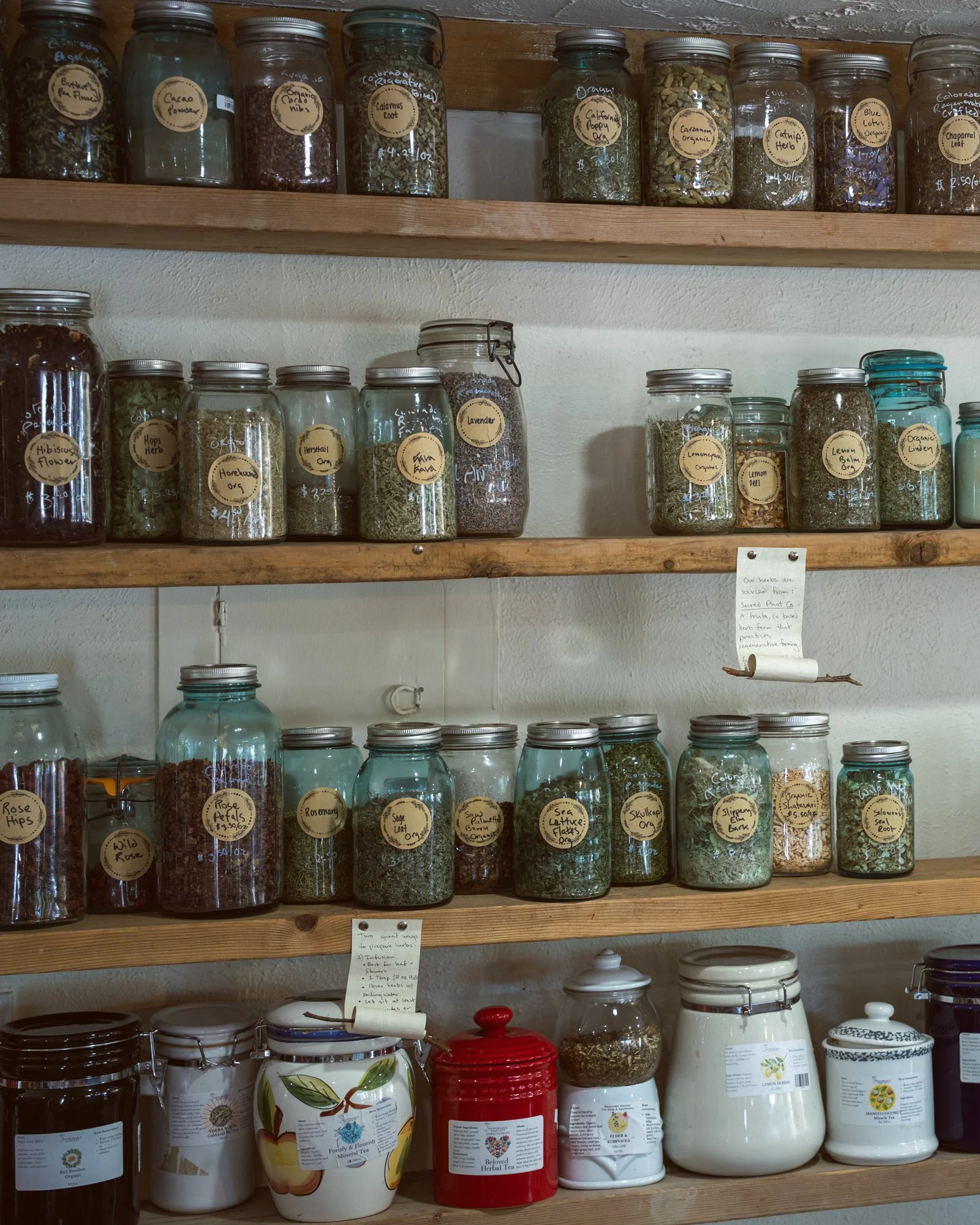 Shelves of sustainably sourced medicinal herbs, loose-leaf botanical blends, and traditional teas.