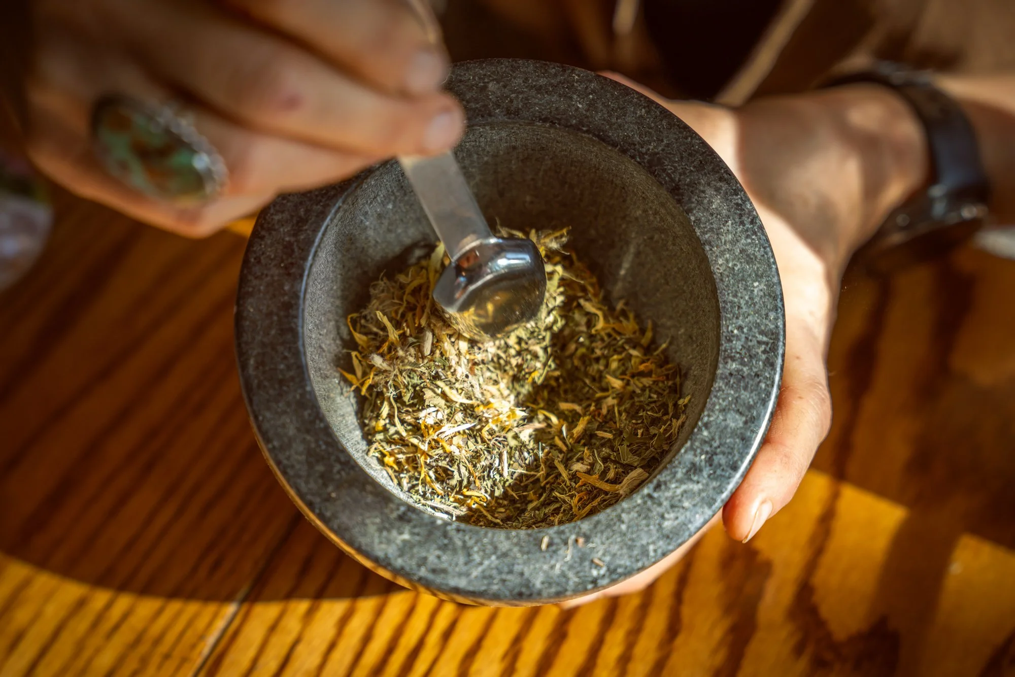 Hand-blending organic, responsibly harvested bulk herbs at Honorable Harvest.