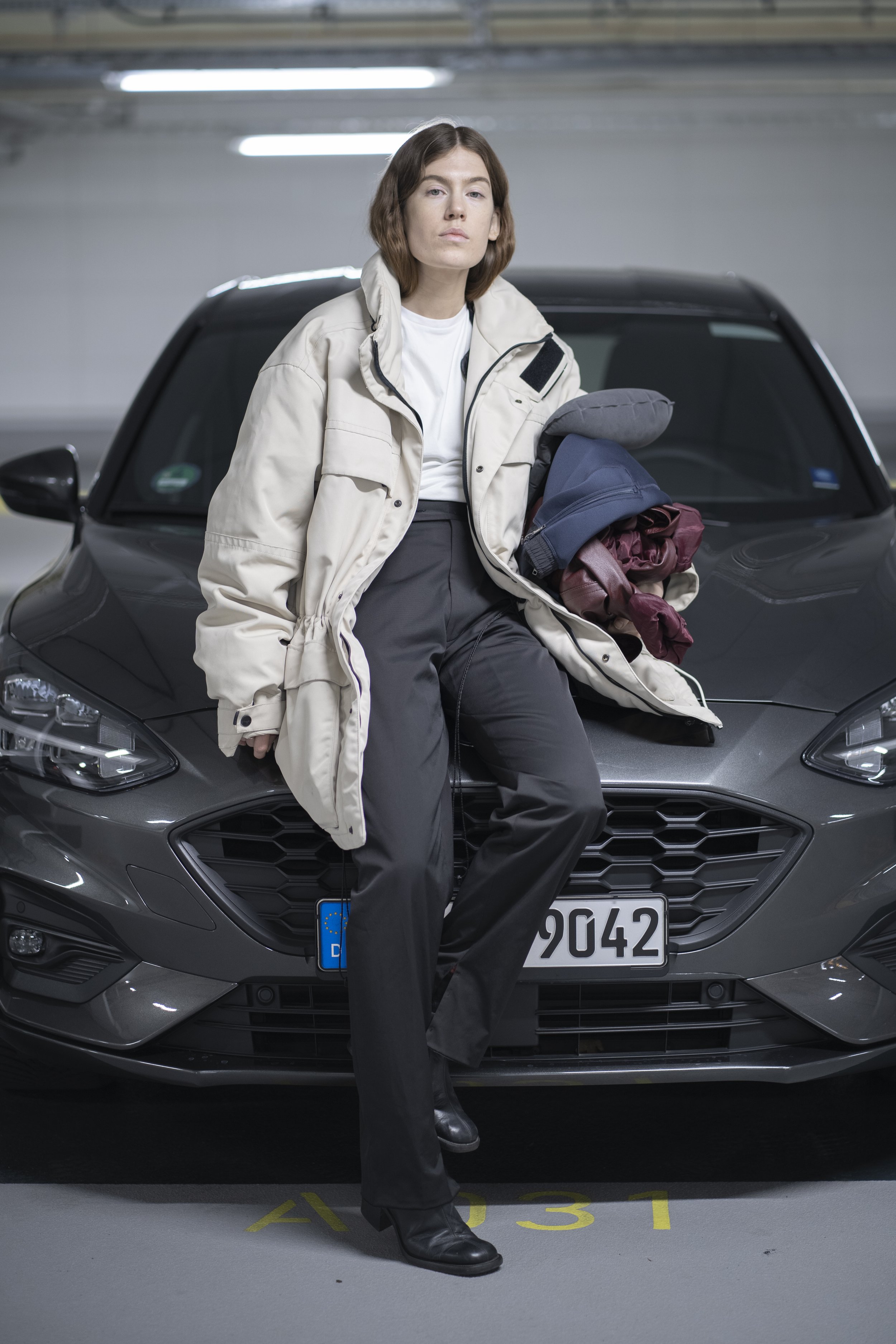 Portrait of a film character from 'Sacred Fire Within', a 2021–2023 film by Daiva Tubutytė. Performance artist Emmilou Roessling is captured while filming an underground parking lot scene in Berlin, Germany.