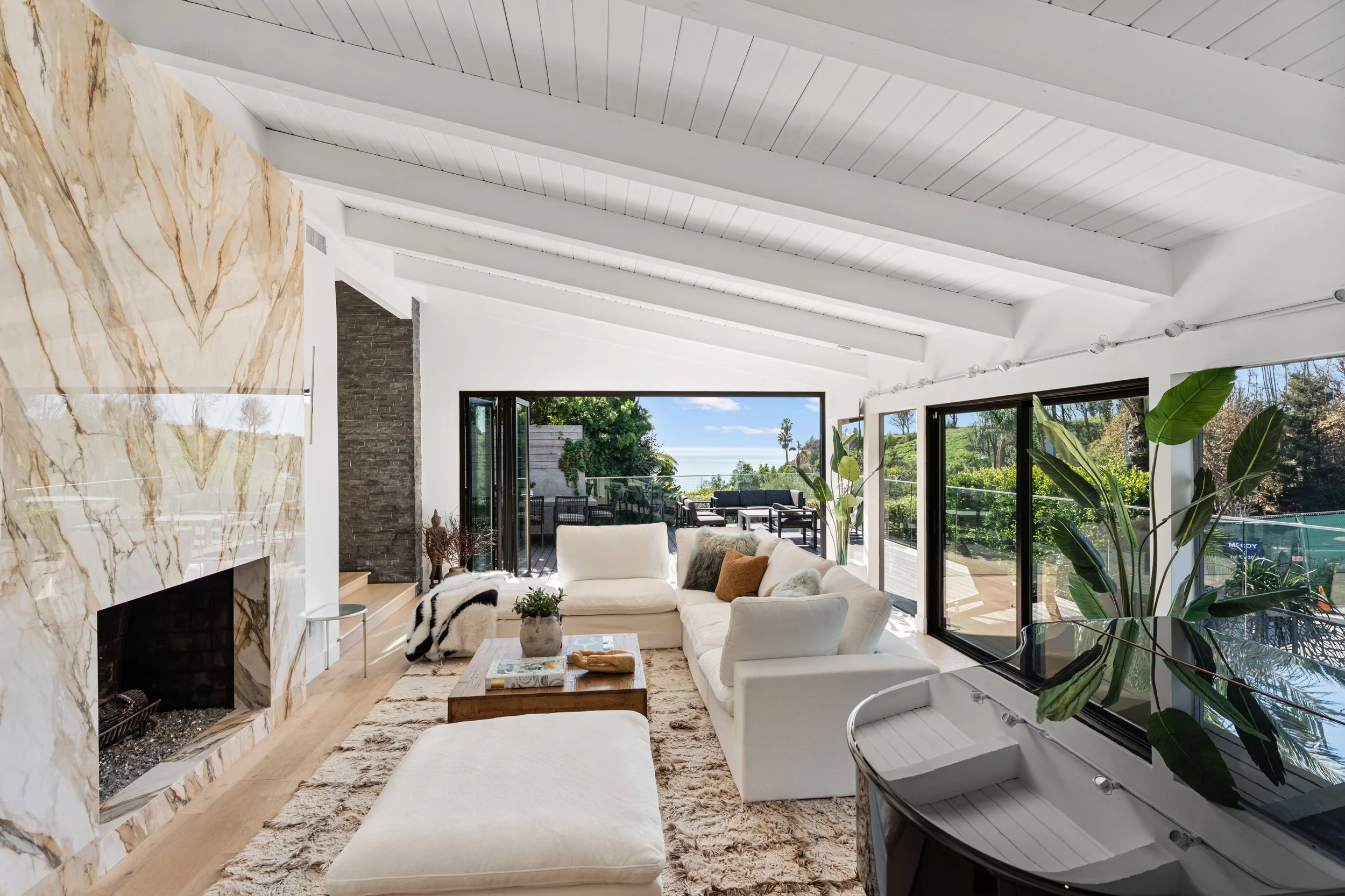 Bright living room with marble fireplace