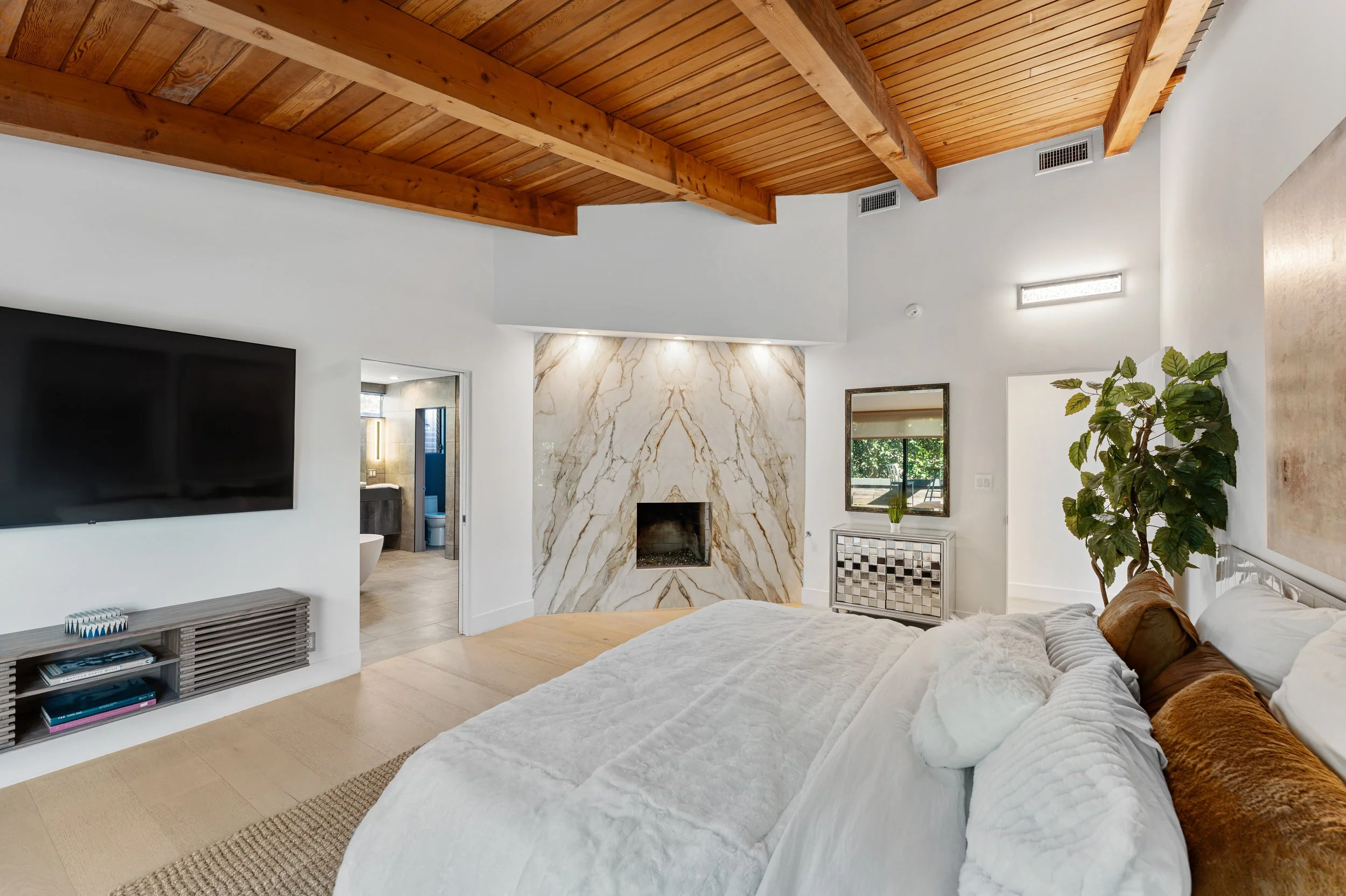 Bright bedroom with marble fireplace accent wall