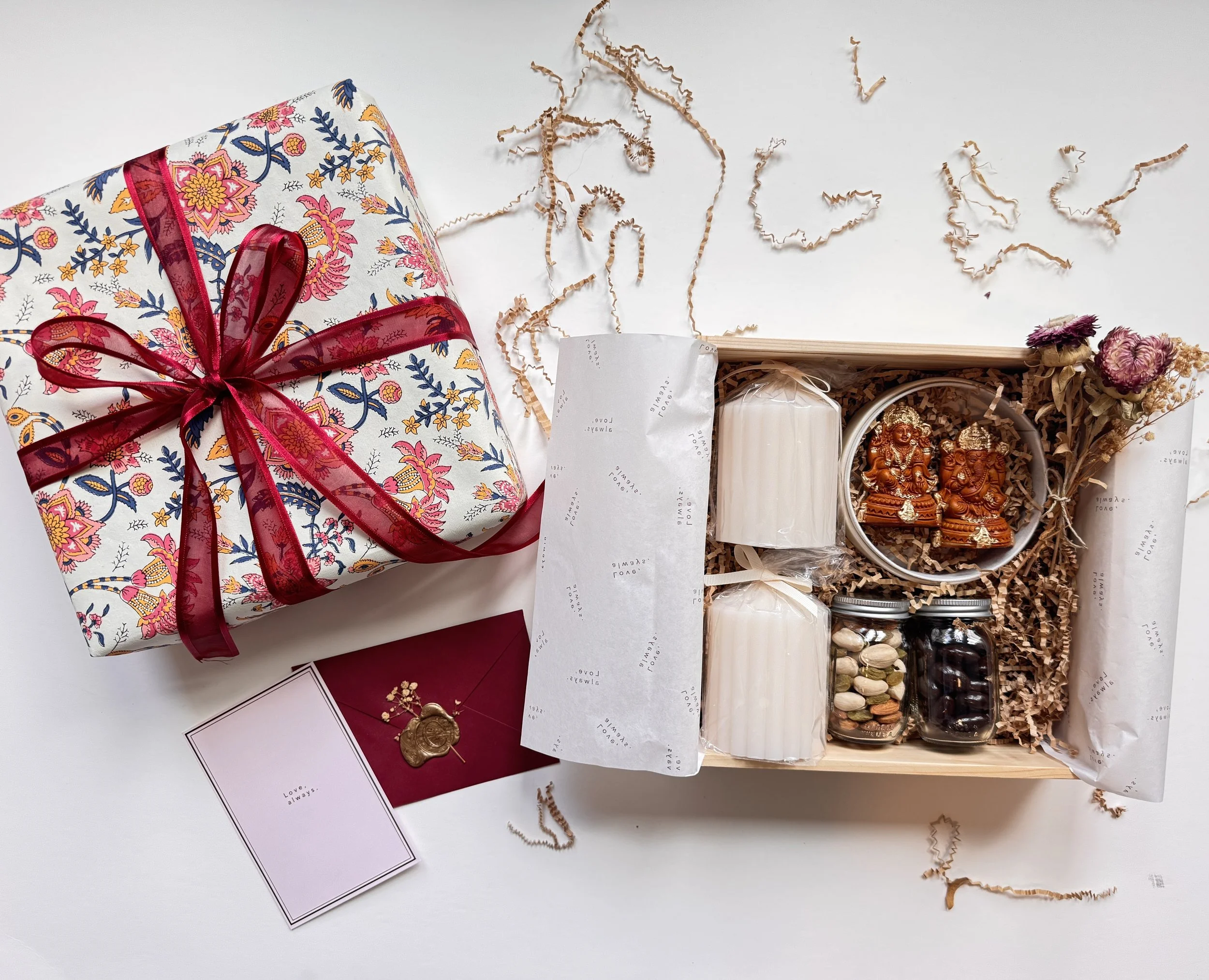 Reusable wooden box wrapped in festive floral fabric and tied with a rich maroon organza ribbon.