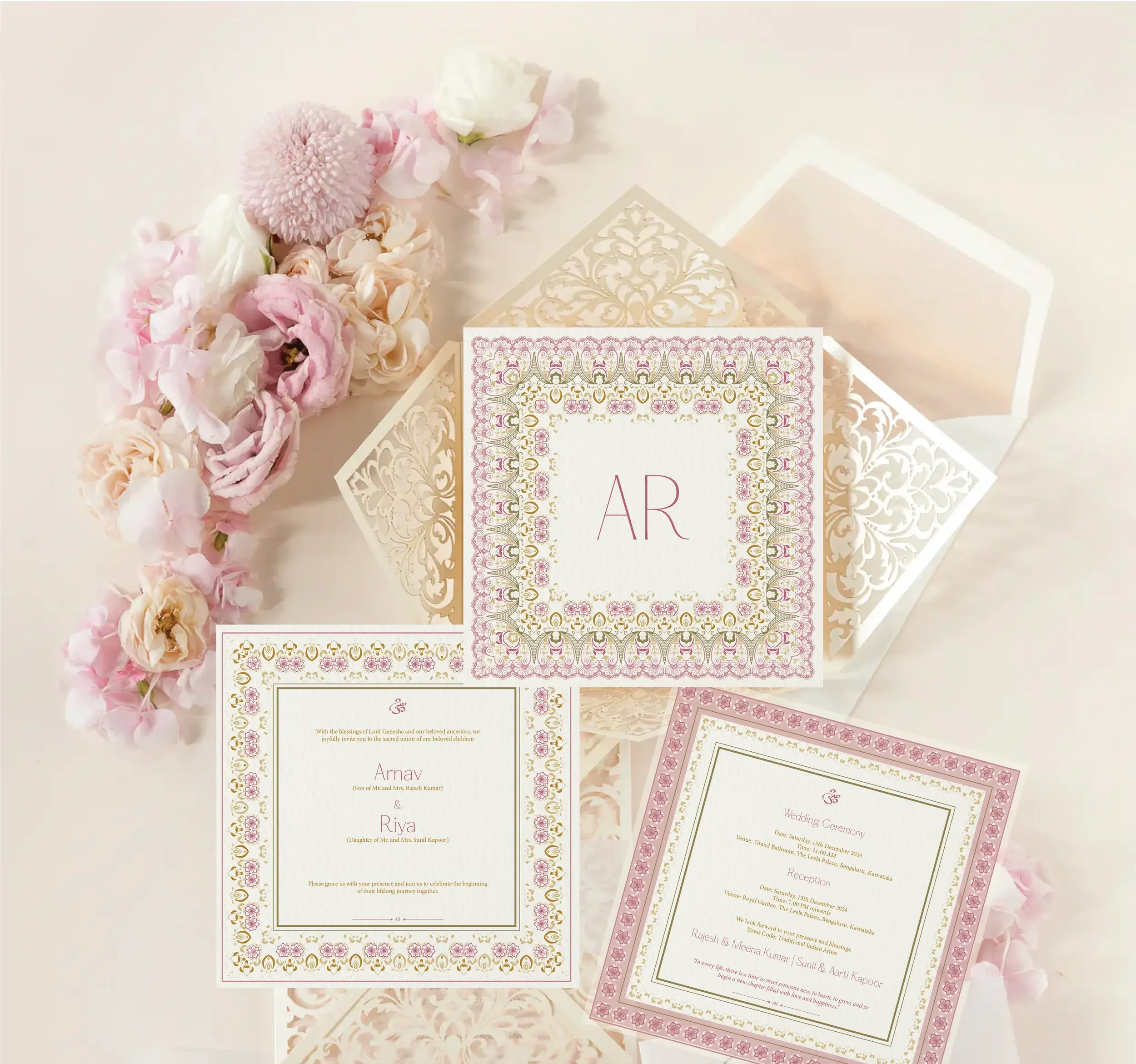 Elegant wedding invitation cards with floral borders, placed on an intricate white box and decorated with pink and white flowers.