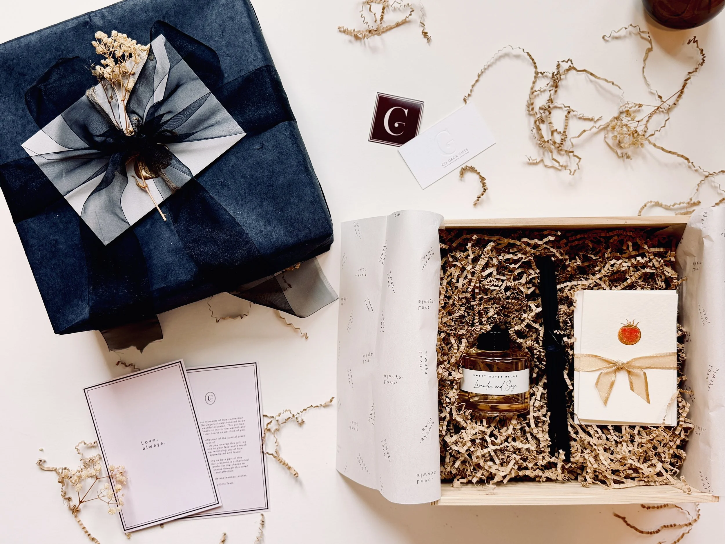 Minimalist luxury gift box in pinewood packaging with navy velvet ribbon and dried floral accent, designed for thank-you gifting.