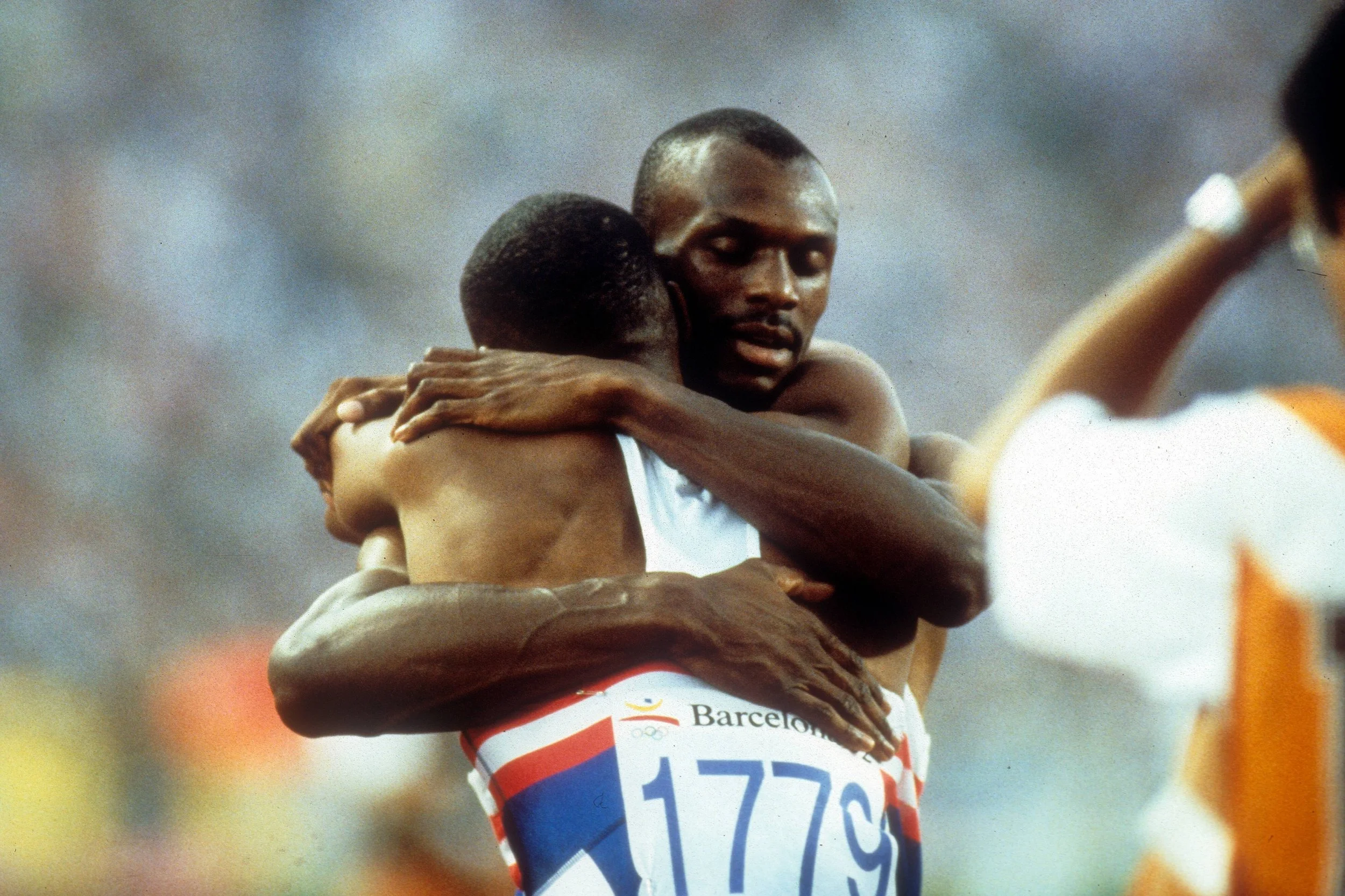 Steve Lewis hugs Quincy Watts after taking the silver and bronze medals in the 400m at the 1992 Barcelona Olympics - Image courtesy of IMAGO Images