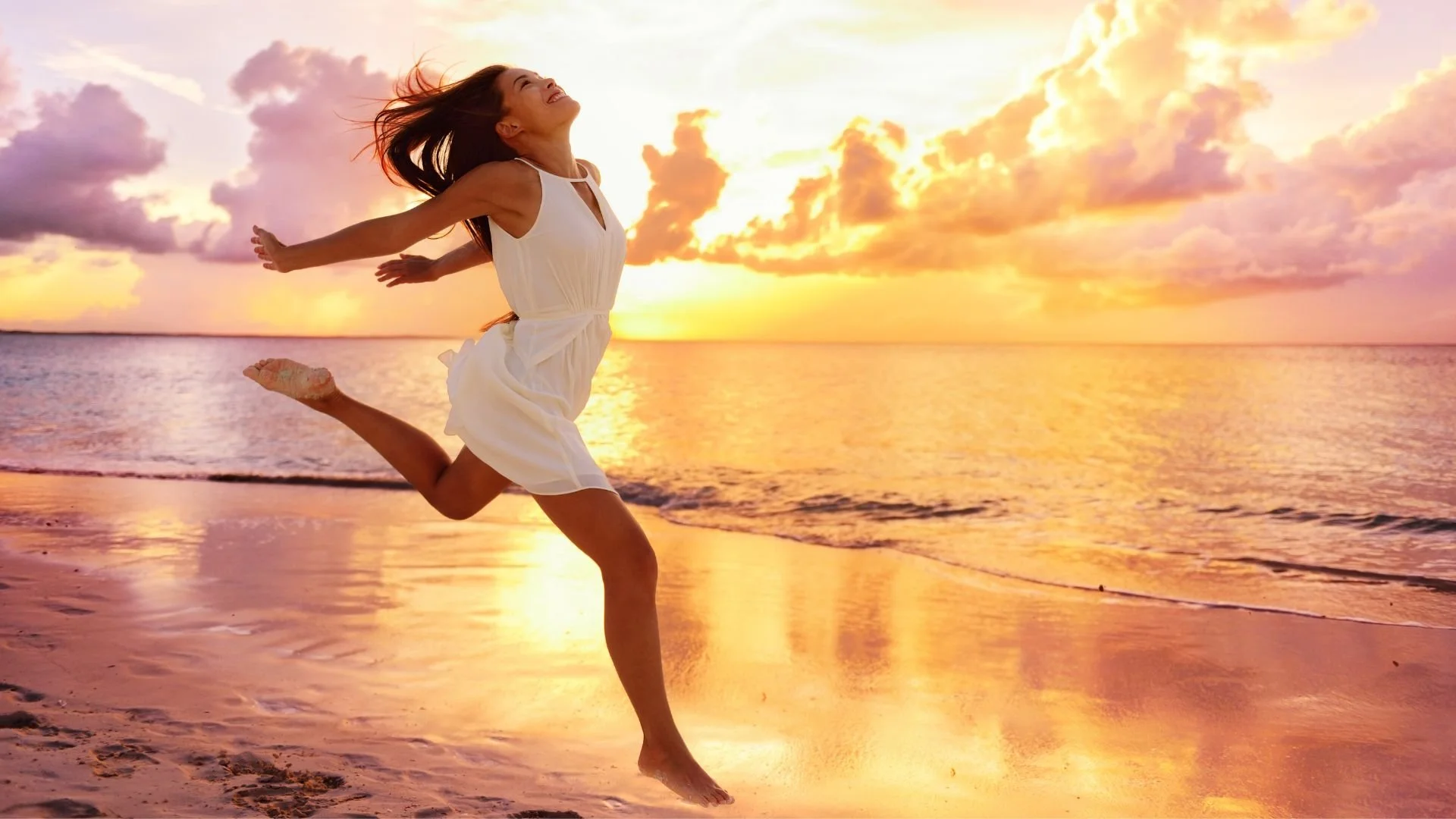 energetic, happy woman running on beach