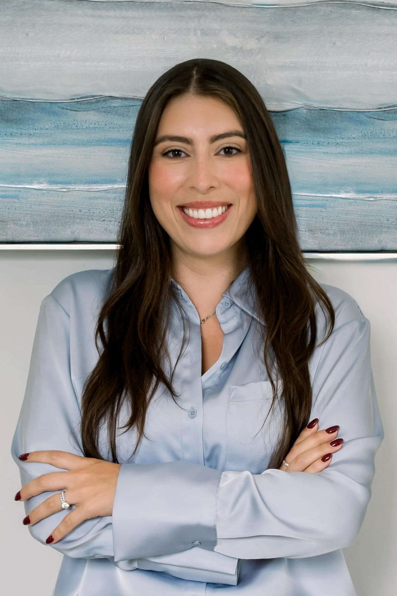 part hispanic wellness dr. in a light blue shirt with arms folded Fort Mill, SC working at Freedom integrative wellness