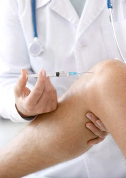 A healthcare professional administering a vaccine injection into a patient's shoulder.