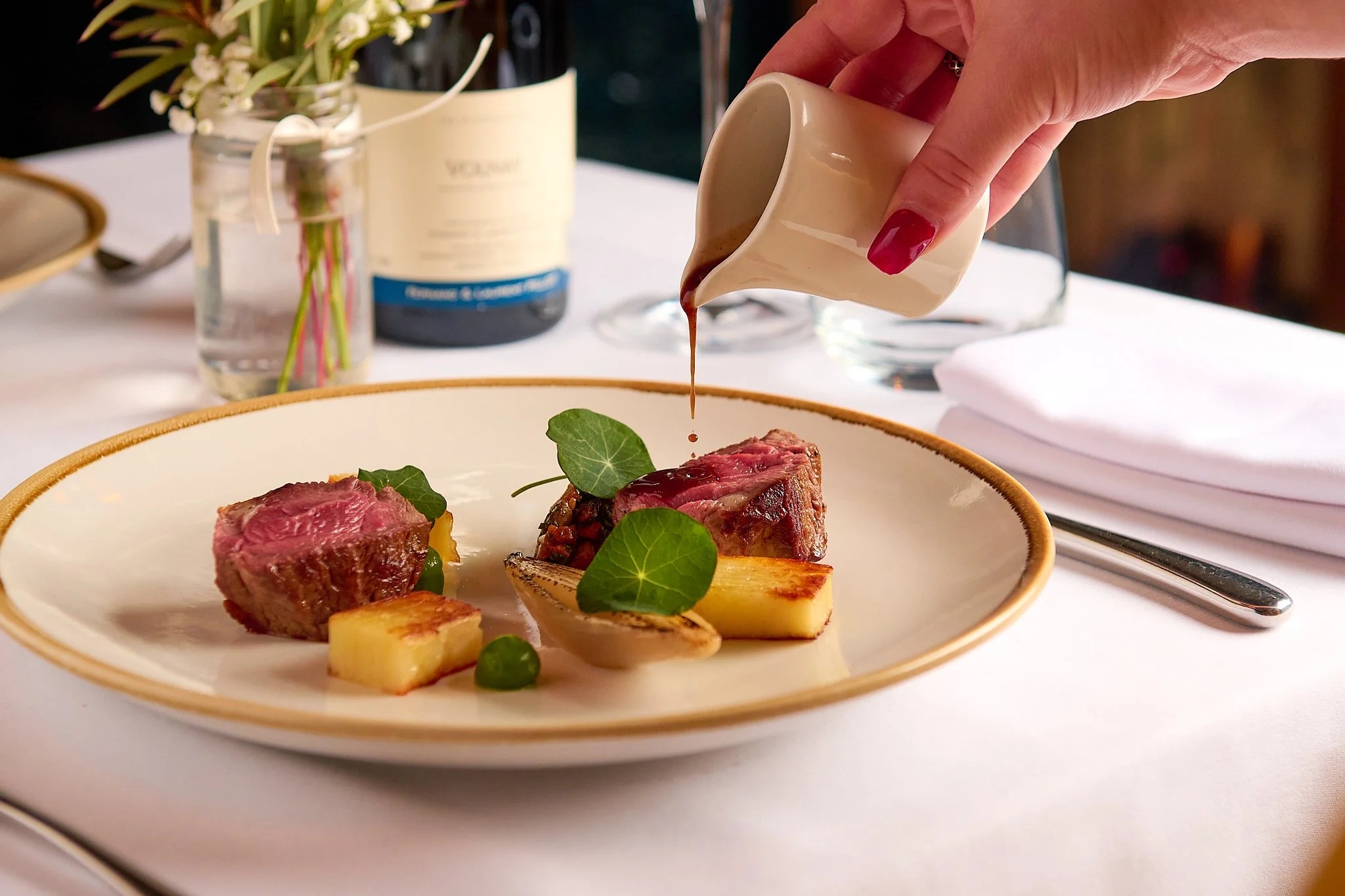 Roseate Edinburgh beef dish with sauce pour – fine dining food photography Edinburgh
