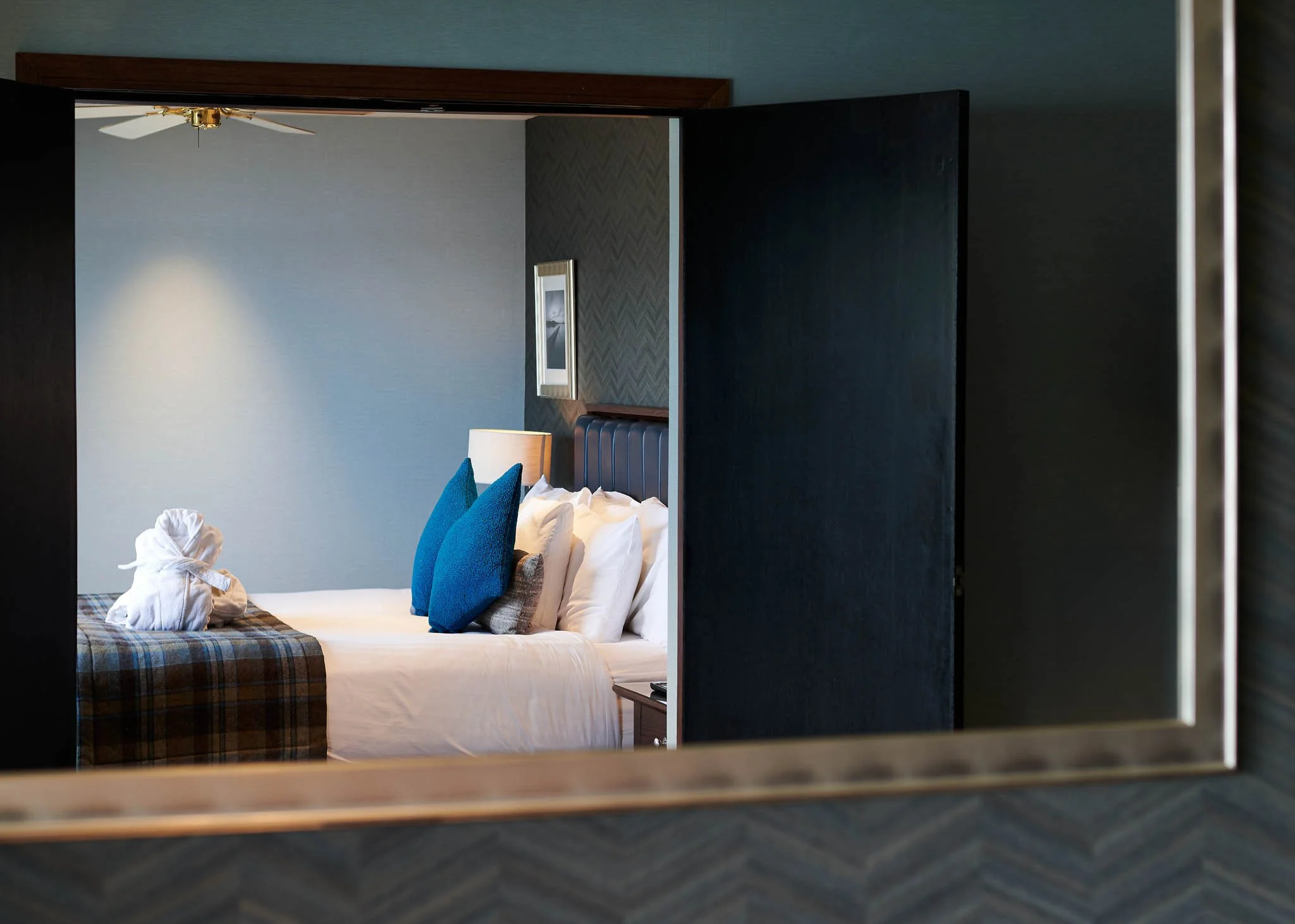 Lodge on Loch Lomond bedroom with blue cushions – hotel room photography Scotland