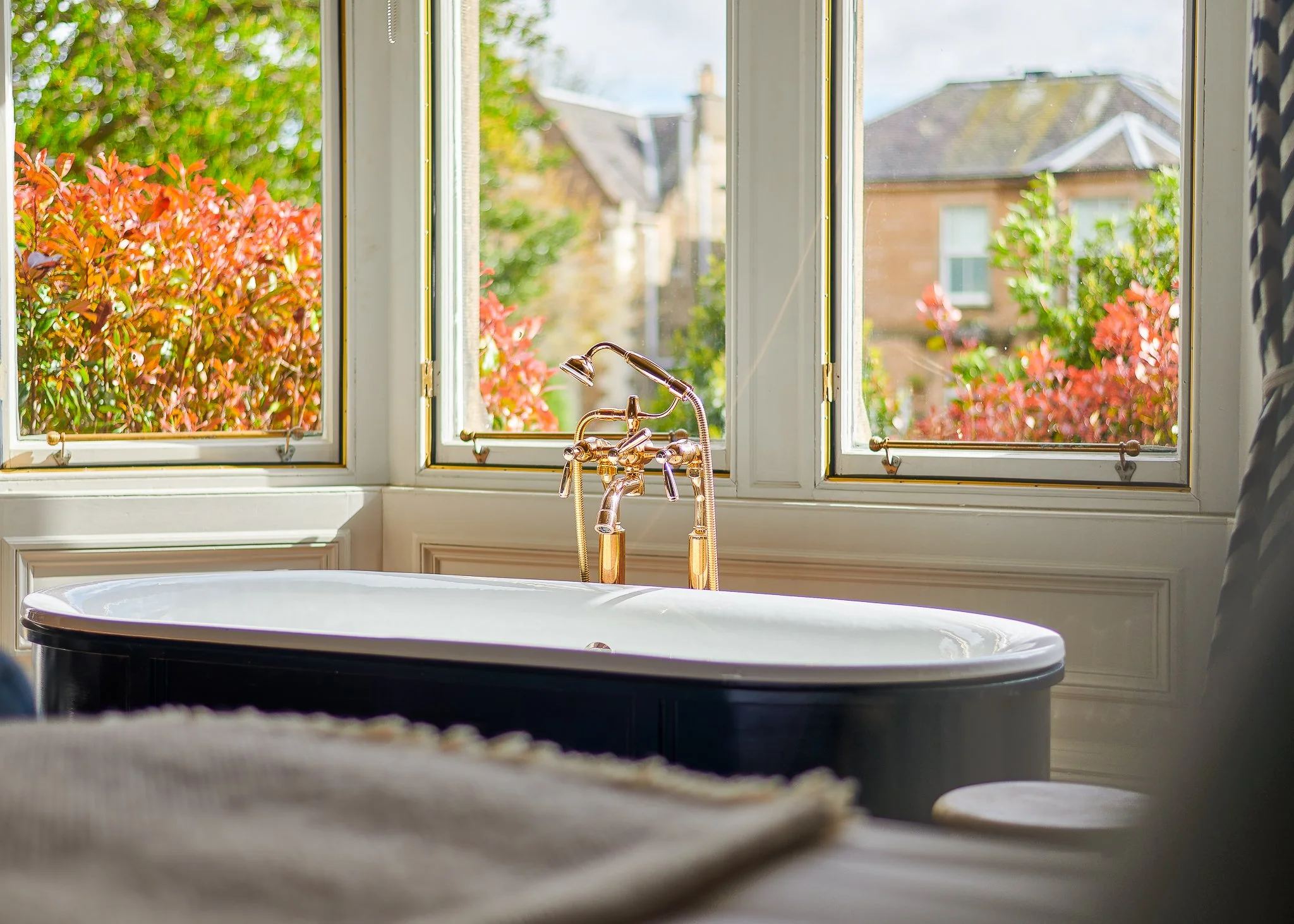 Roseate Edinburgh bathroom with freestanding bath and garden views – hotel photography Edinburgh