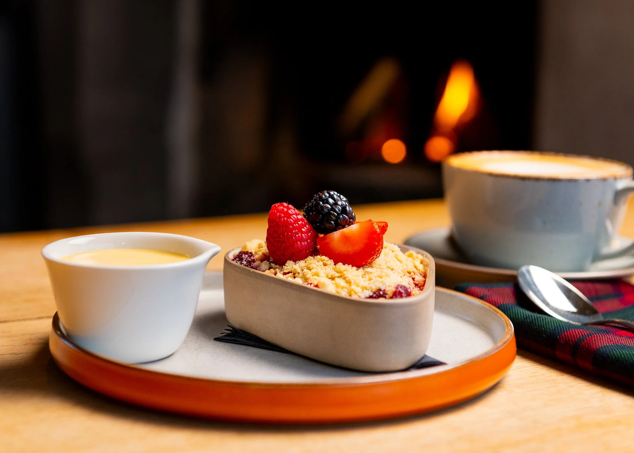 Karma Lake of Monteith crumble dessert by fireplace – hotel restaurant food photography Scotland