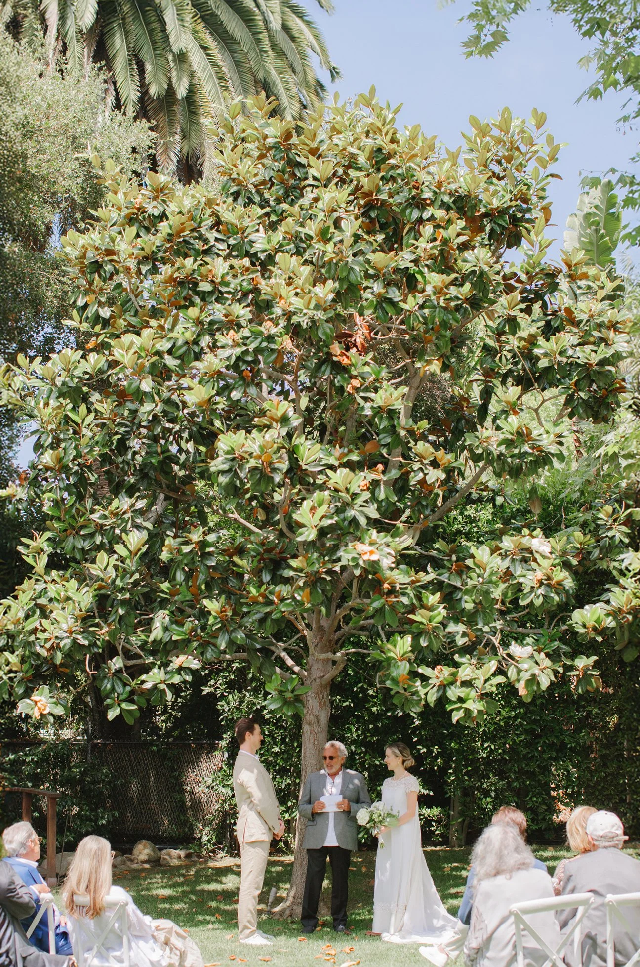 Bride and groom standing together outdoors during their wedding ceremony.