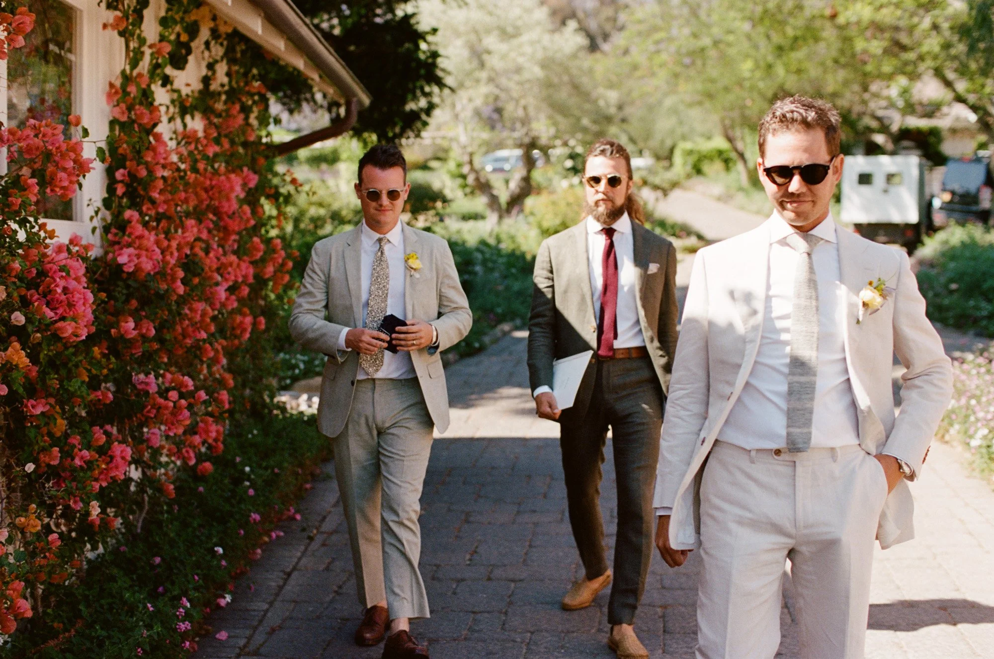 groom and his groomsmen walking photographed by Michael and Anna Costa