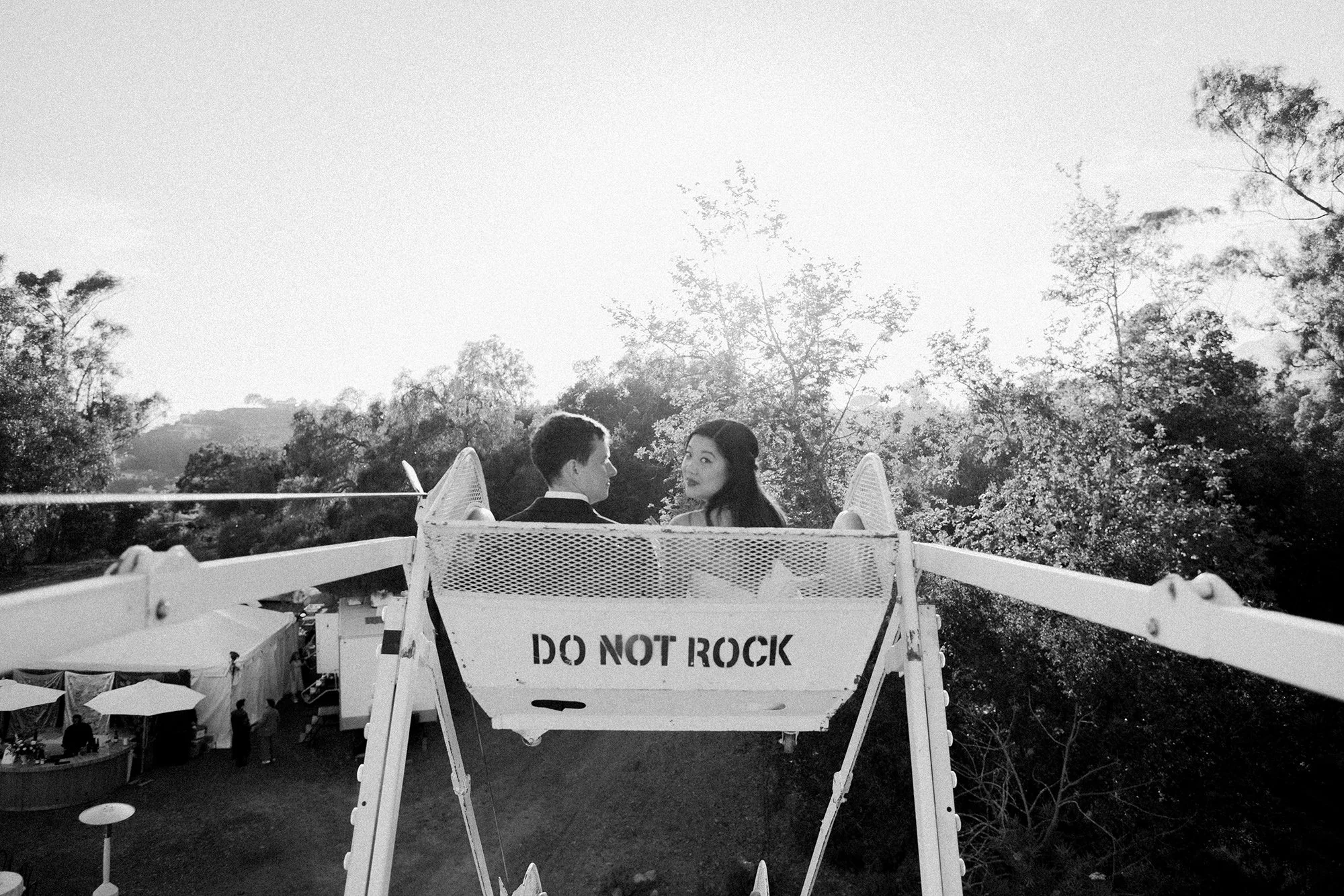 black and white photo of bride and groom in a Ferris Wheel photographed by Michael & Anna Costa