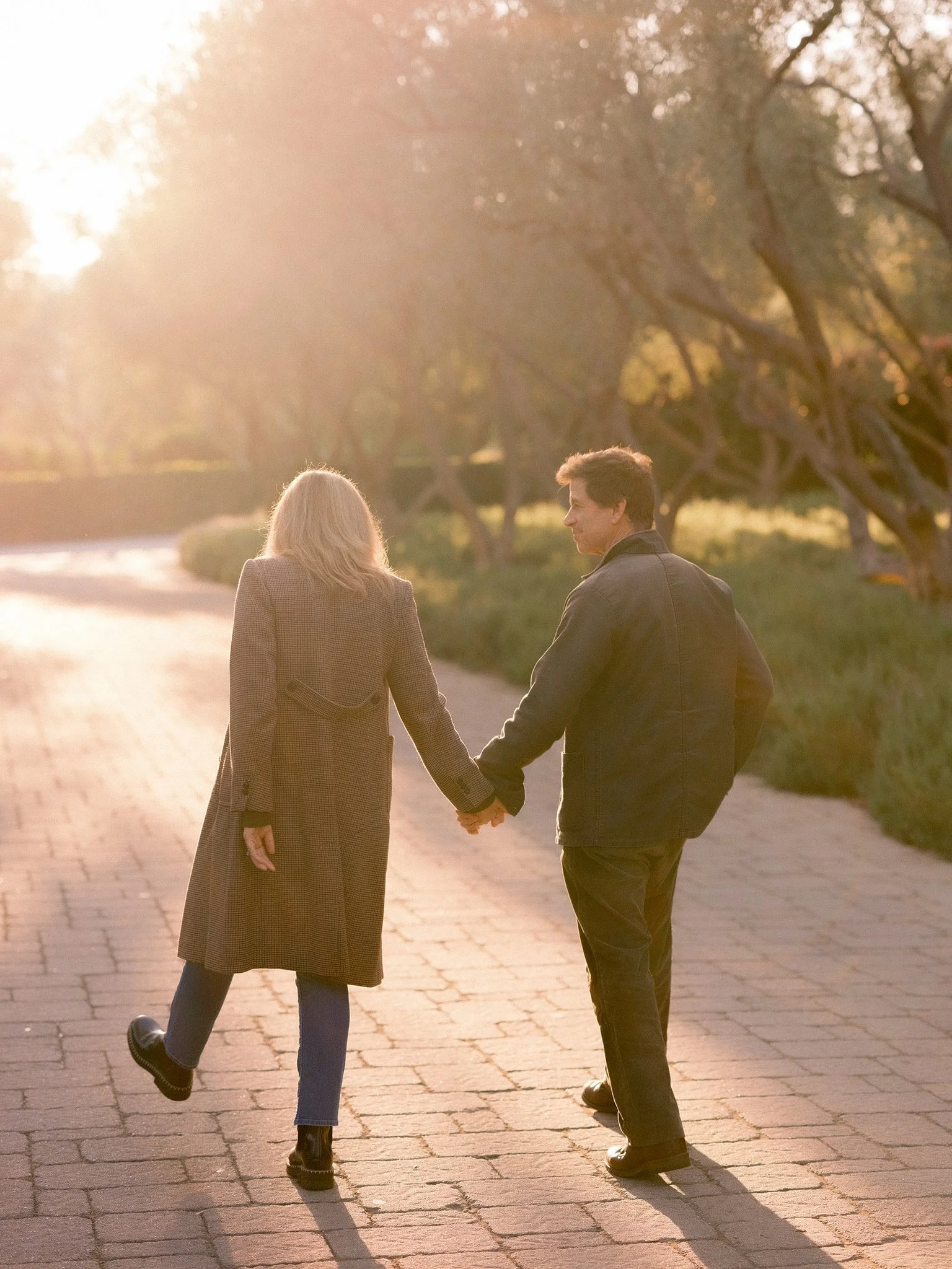 05-debbie-zack-snyder-anniversary-couple-holding-hands-sunlight.jpg.JPG