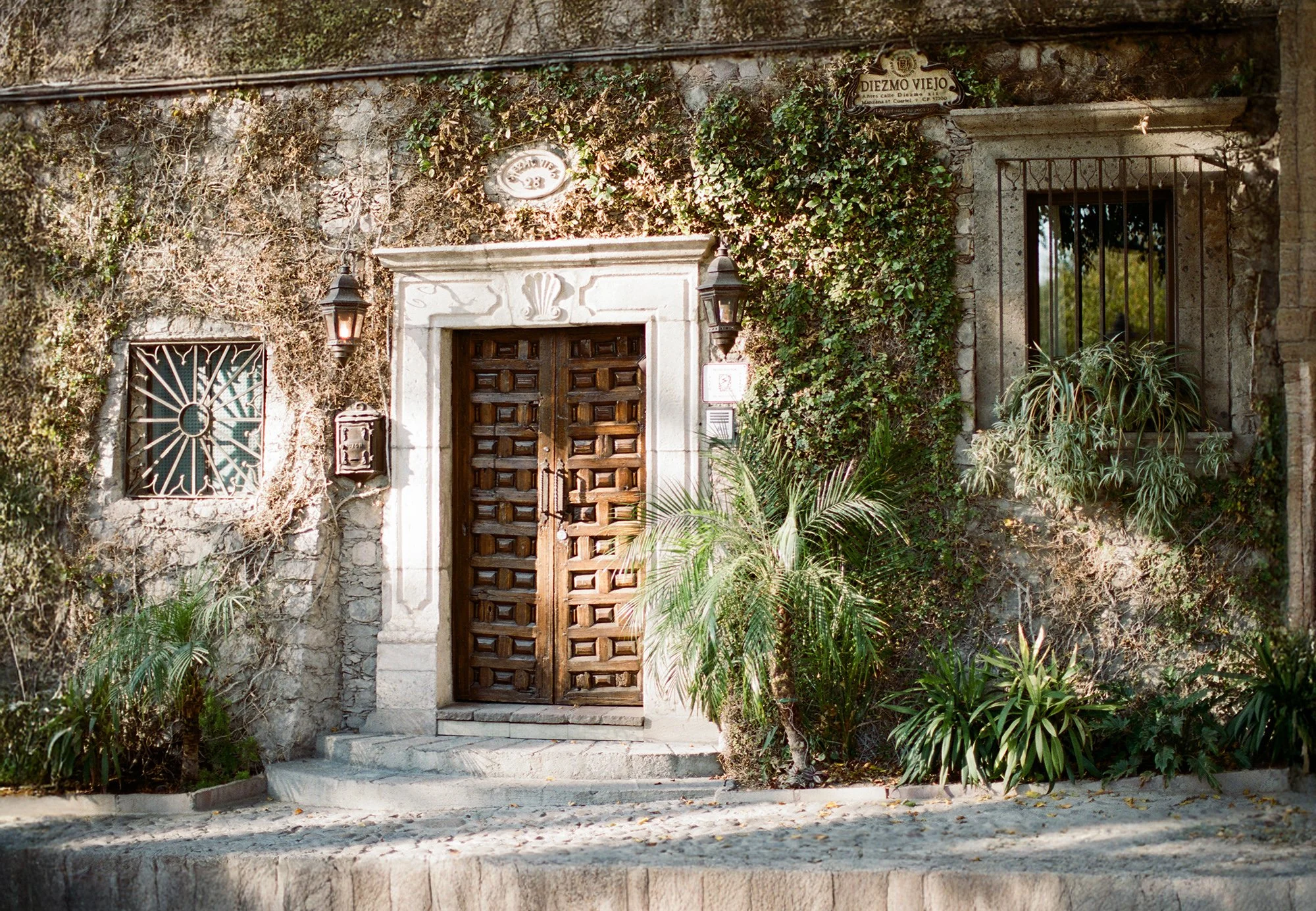 Stone archway entrance surrounded by greenery at Belmond Resort Casa de Sierra Nevada.