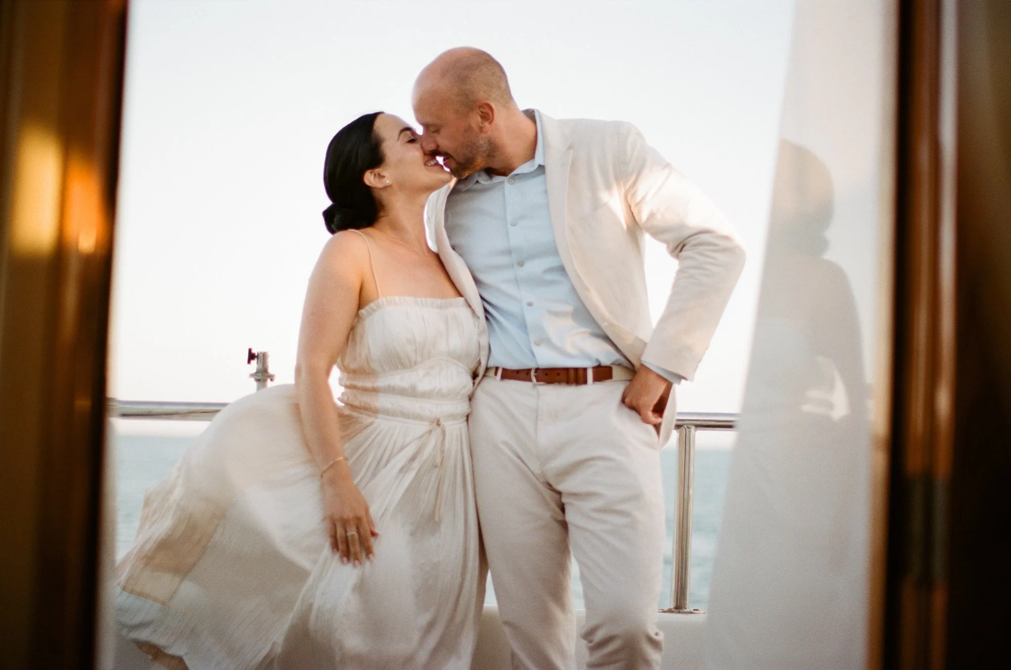 Groom dipping the bride as they dance on the yacht.