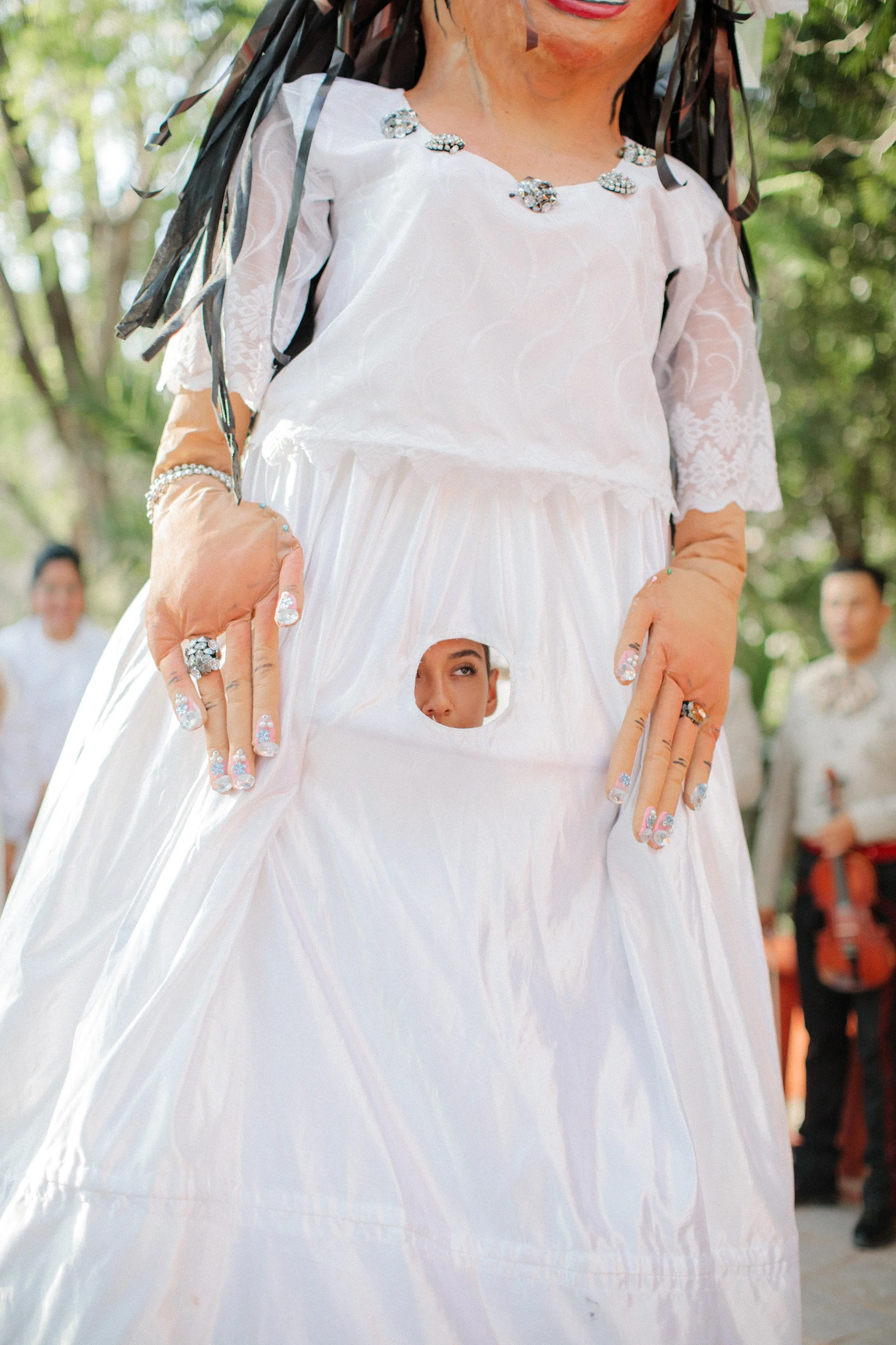 Bride holding bouquet of white flowers in a close-up shot.
