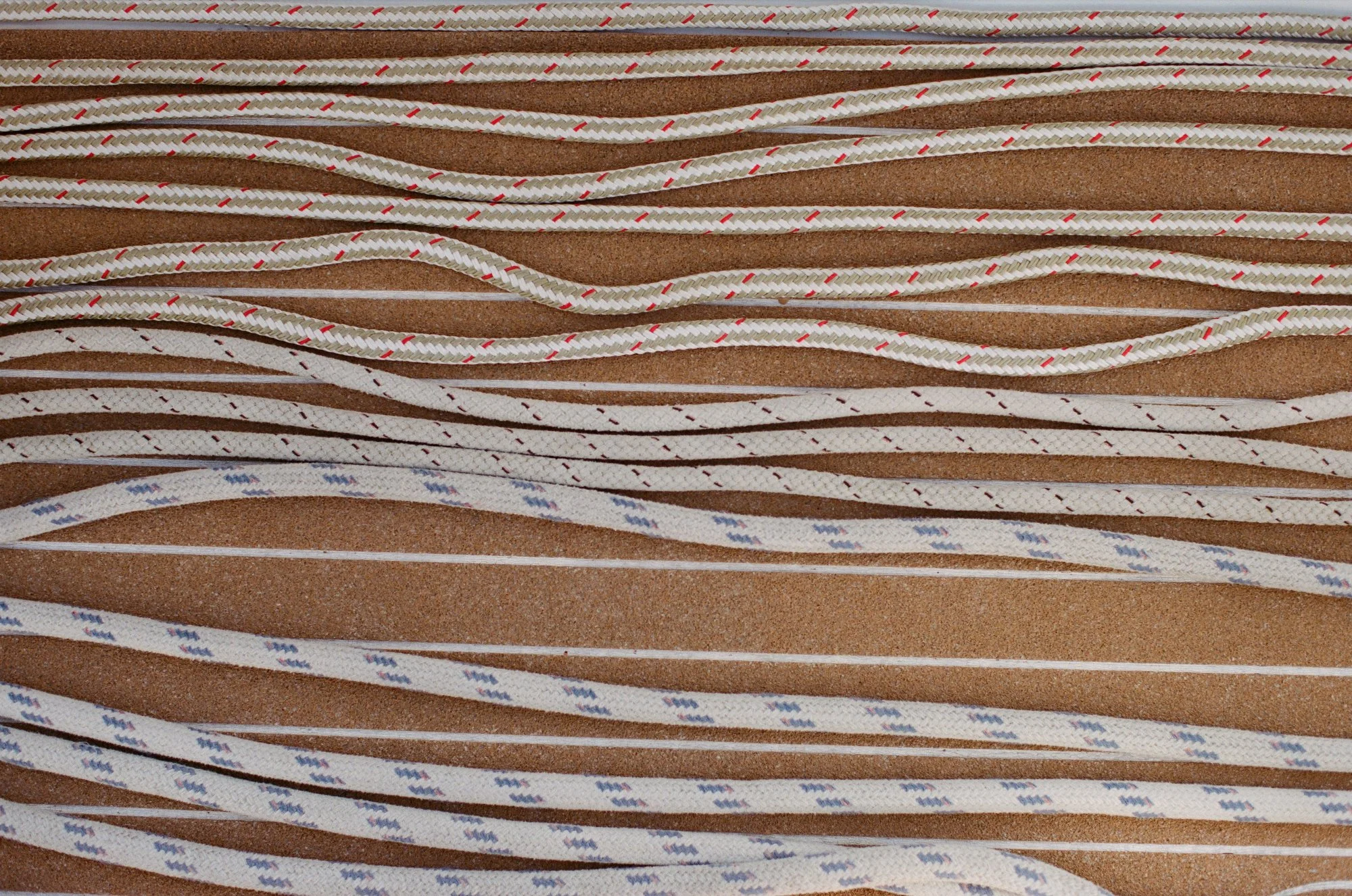 Close-up of textured yacht ropes arranged in neat rows.