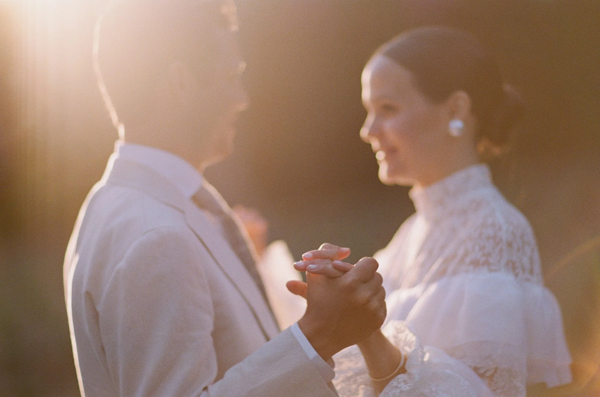 Bride and groom sharing a first dance outdoors at San Ysidro Ranch wedding, photographed by Michael & Anna Costa