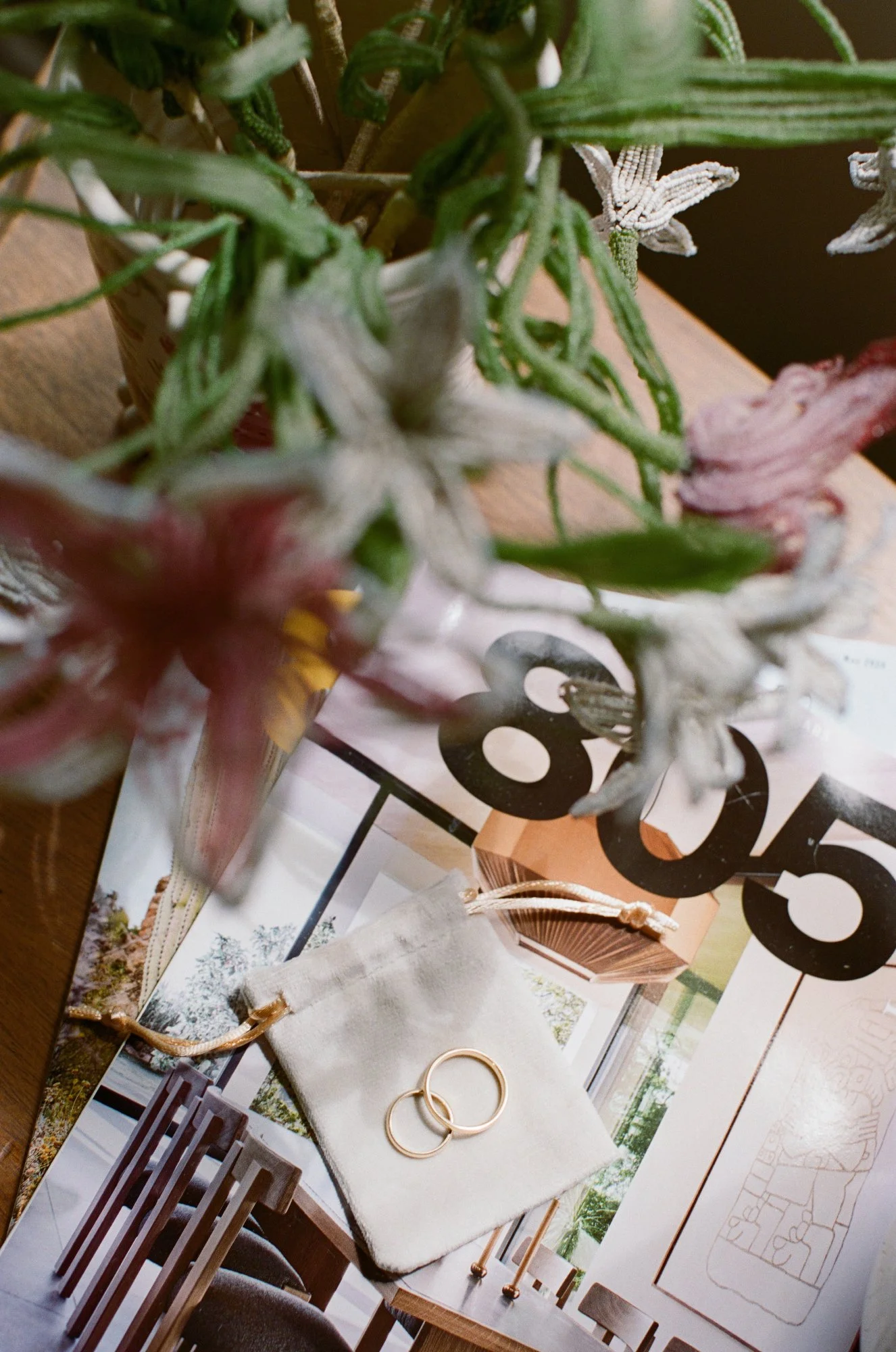 Artistic flat lay of wedding accessories, including rings, shoes, and floral details.