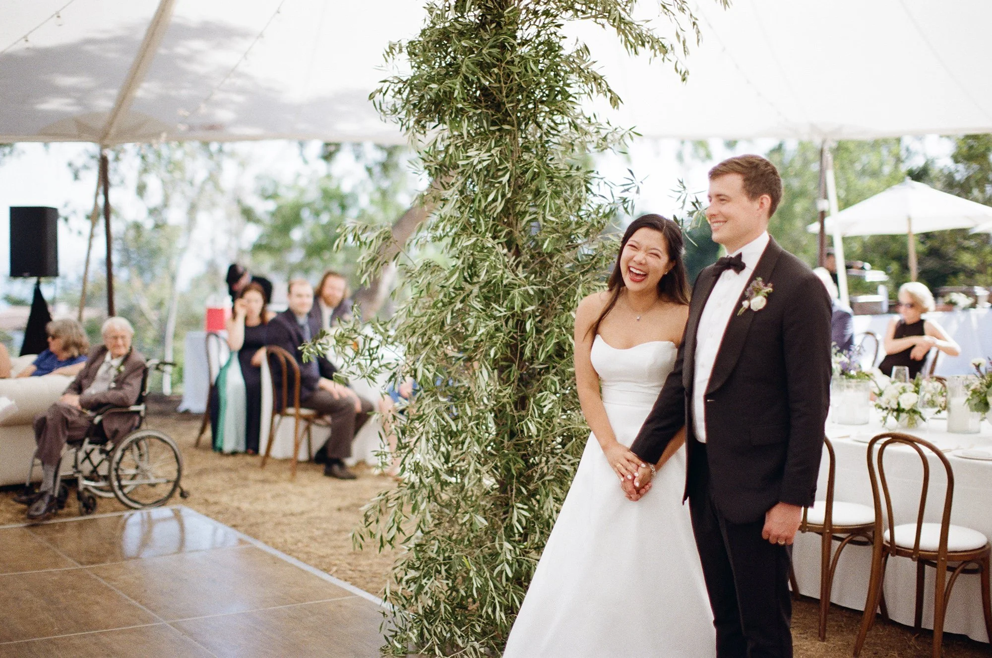 bride and groom at an outside wedding reception photographed by Michael & Anna Costa