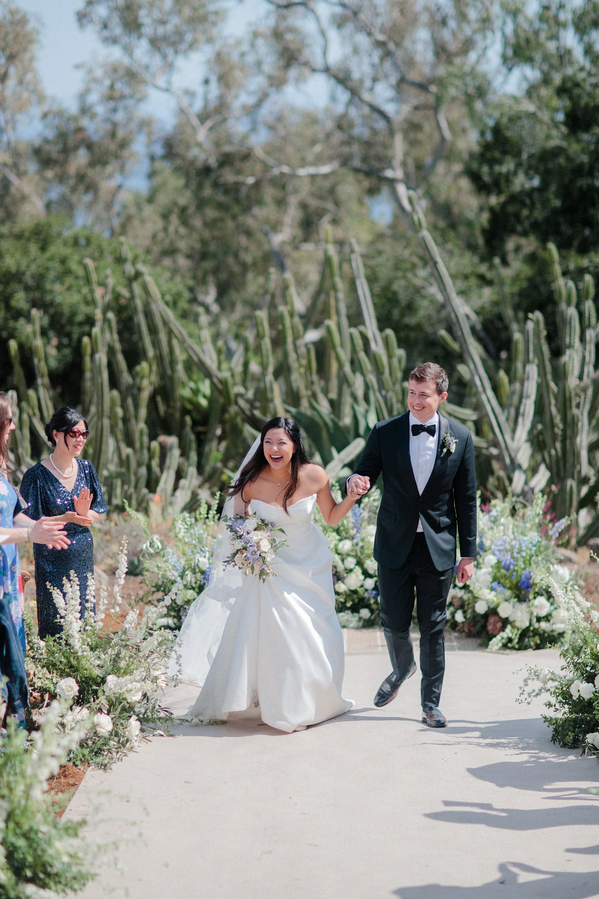 bride and groom doing their celebratory walk photographed by Michael and Anna Costa