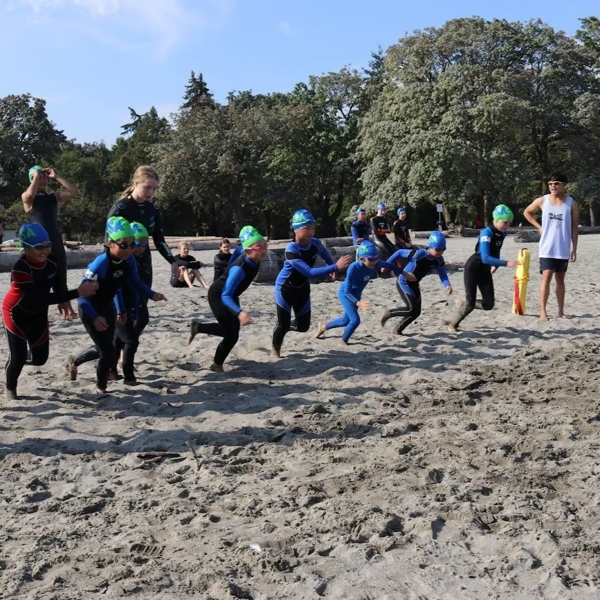 Young Pacific Lifesaving Club athletes running into the water