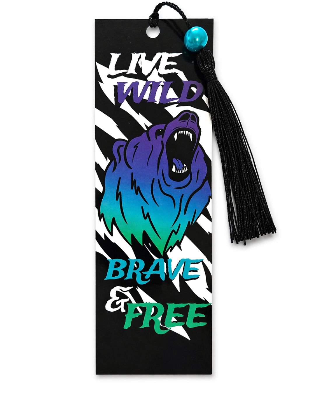 A decorative bookmark with a roaring bear illustration and the words 'Live Wild, Brave & Free' in colorful fonts, adorned with a black tassel with a blue bead.