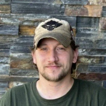 man in a hat and green shirt
