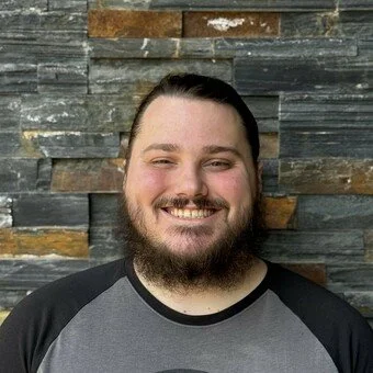 smiling man in a black shirt