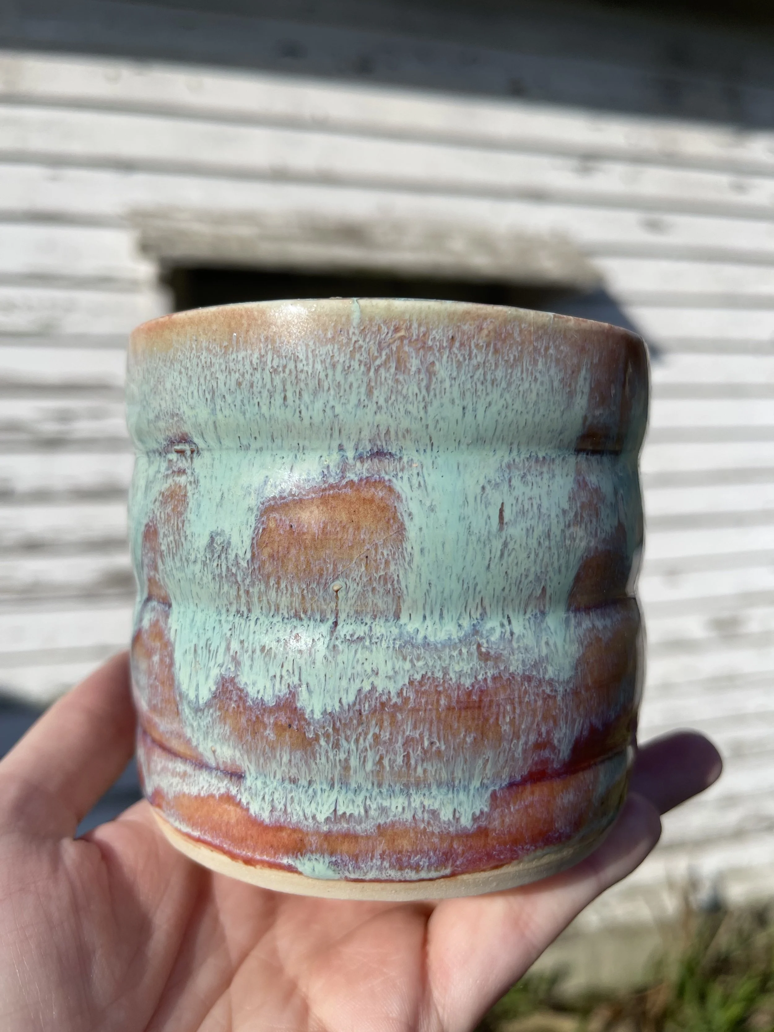 Textured Ceramic Pot with Layered Green & Rust Glaze | Handmade by Stray Cat Studios
This handmade ceramic pot features a soft, ridged form and layered glaze in mint green, rust, and violet tones. A bold and dreamy piece—crafted for the curious.