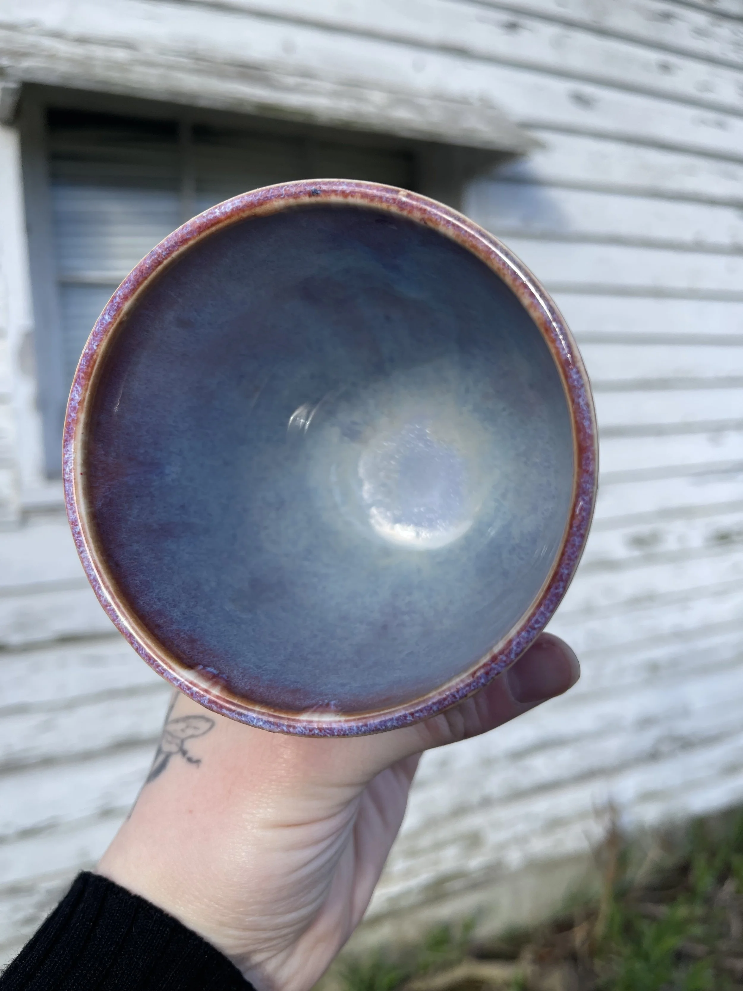 Handmade Ceramic Cup | Fiery Red & Smoky Blue Glaze by Stray Cat Studios
This handmade ceramic cup features a dreamy swirl of lavender and stormy blue glaze inside—subtle, smooth, and deeply hypnotic. Like sipping your favorite drink inside a cloud a