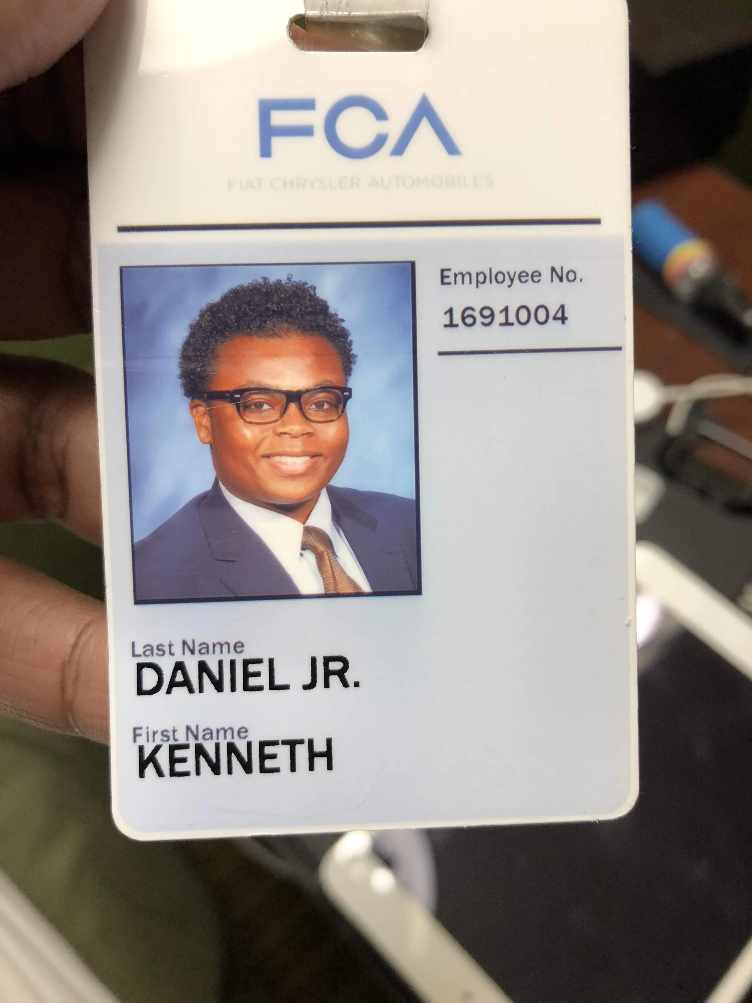 Employee ID badge for Kenneth Daniel Jr. featuring a professional headshot with glasses, a suit, and a tie, issued by FCA (Fiat Chrysler Automobiles).