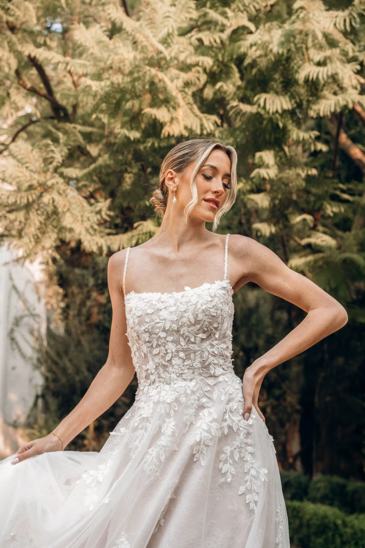 Lace and tulle floral natural waist Stella York a-line wedding gown. Chantilly lace layer with leafy floral appliques and beaded spaghetti straps.