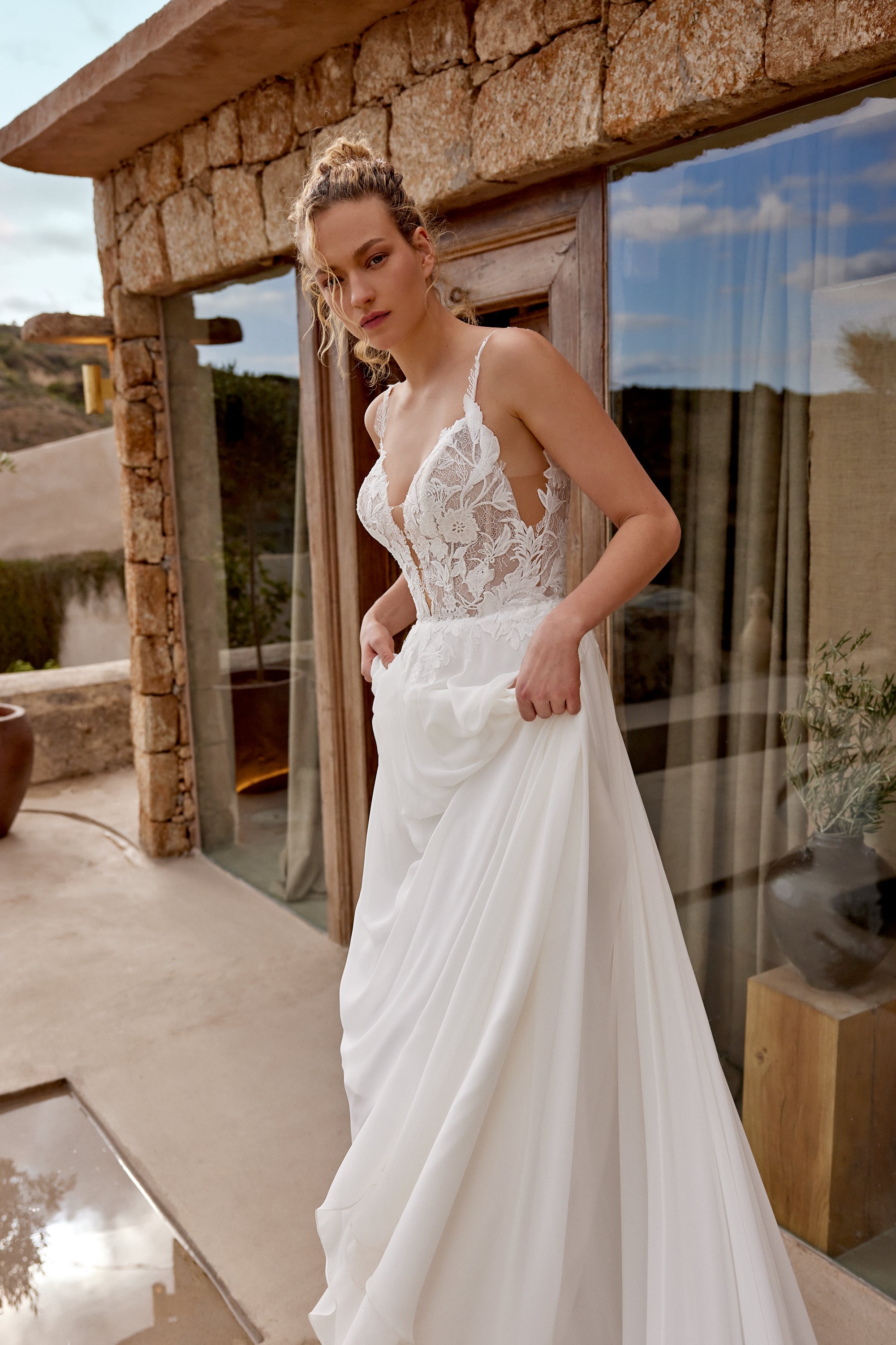 Lillian West wedding dress with chiffon skirt and floral lace bodice with thin floral straps.