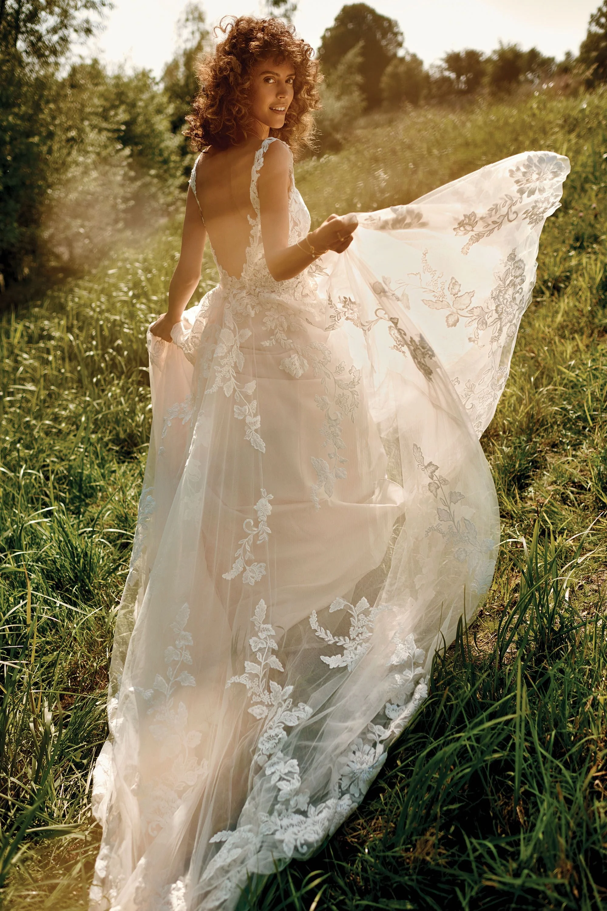 Lace and tulle Lillian West wedding gown with low back and thick lace straps.