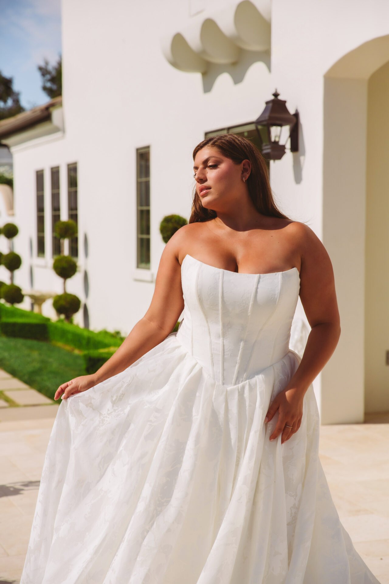 Basque waist Essense of Australia wedding dress with organza fabric and jacquard texture. Corset boning with cat eye neckline bodice.