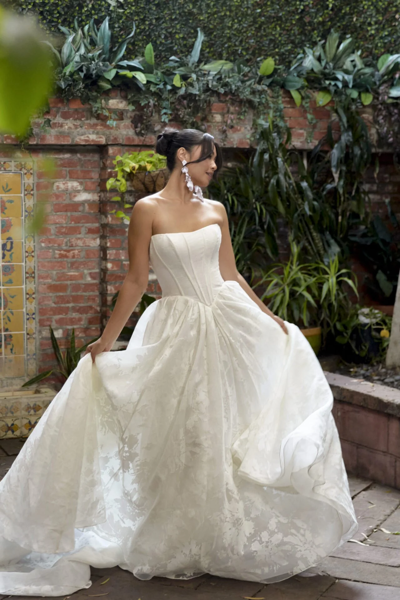 Organdy jacquard Essense of Australia wedding gown with lightweight flowing skirt and basque waist with exposed boning and corset look bodice.