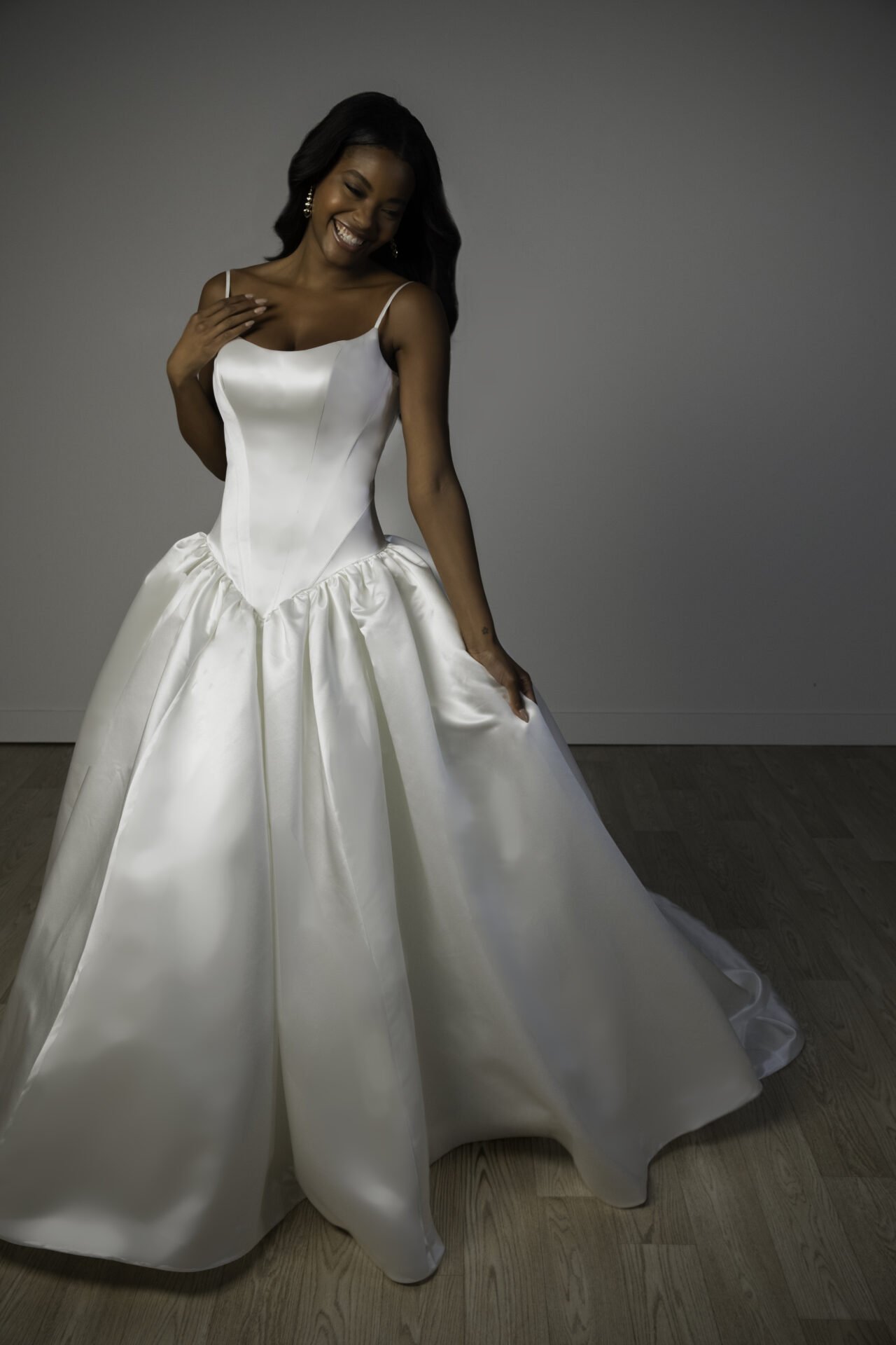 Dropped basque waist satin Stella York ball gown with full skirt. Swoop neckline leading into spaghetti straps.