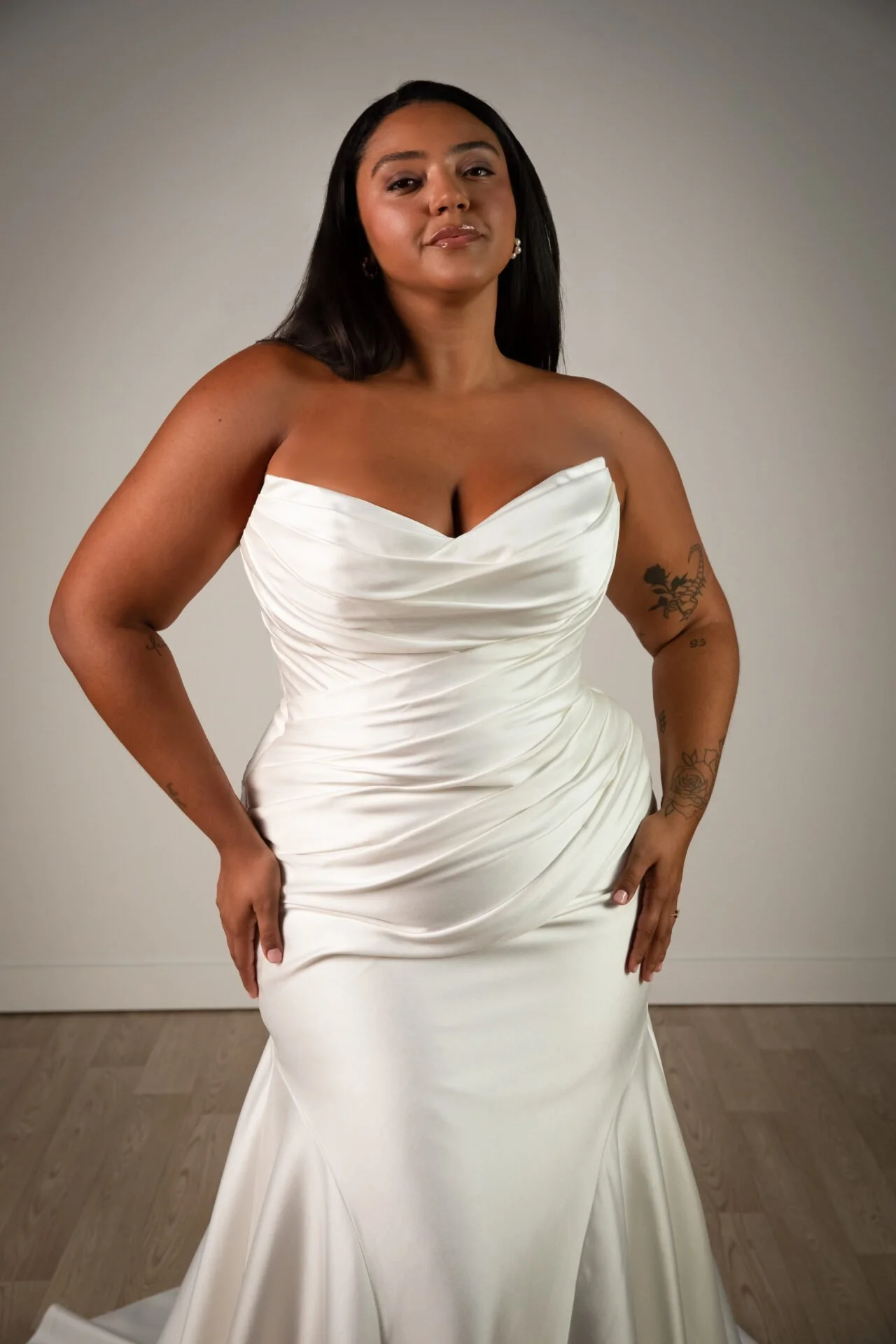 Plus sized fit-and-flare satin Stella York wedding dress. Fitted through the hips to the knee with long, flared train. 