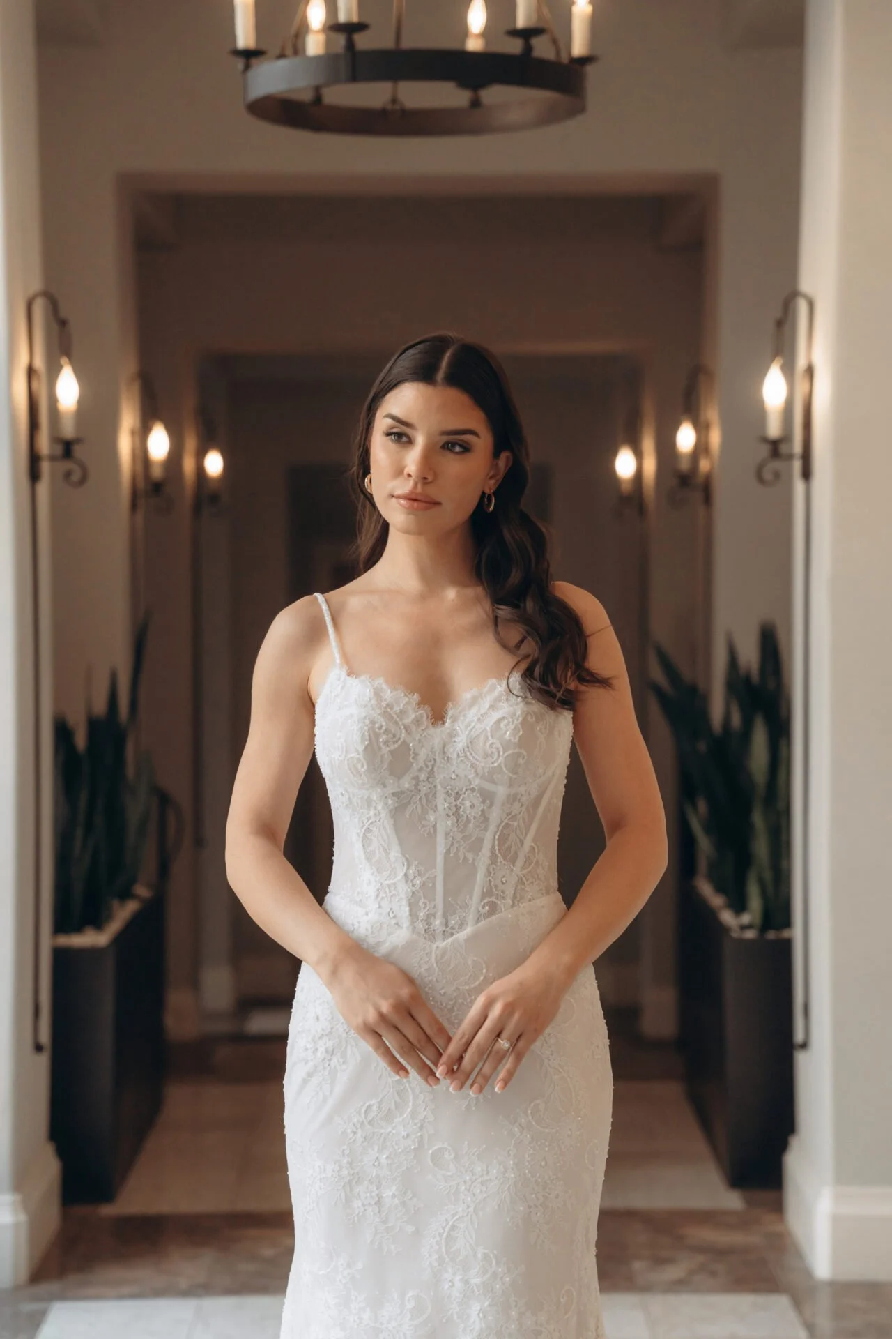 Fitted all-lace Stella York wedding dress with corset look bodice and exposed boning. Basque waist fitted throughout the hips.