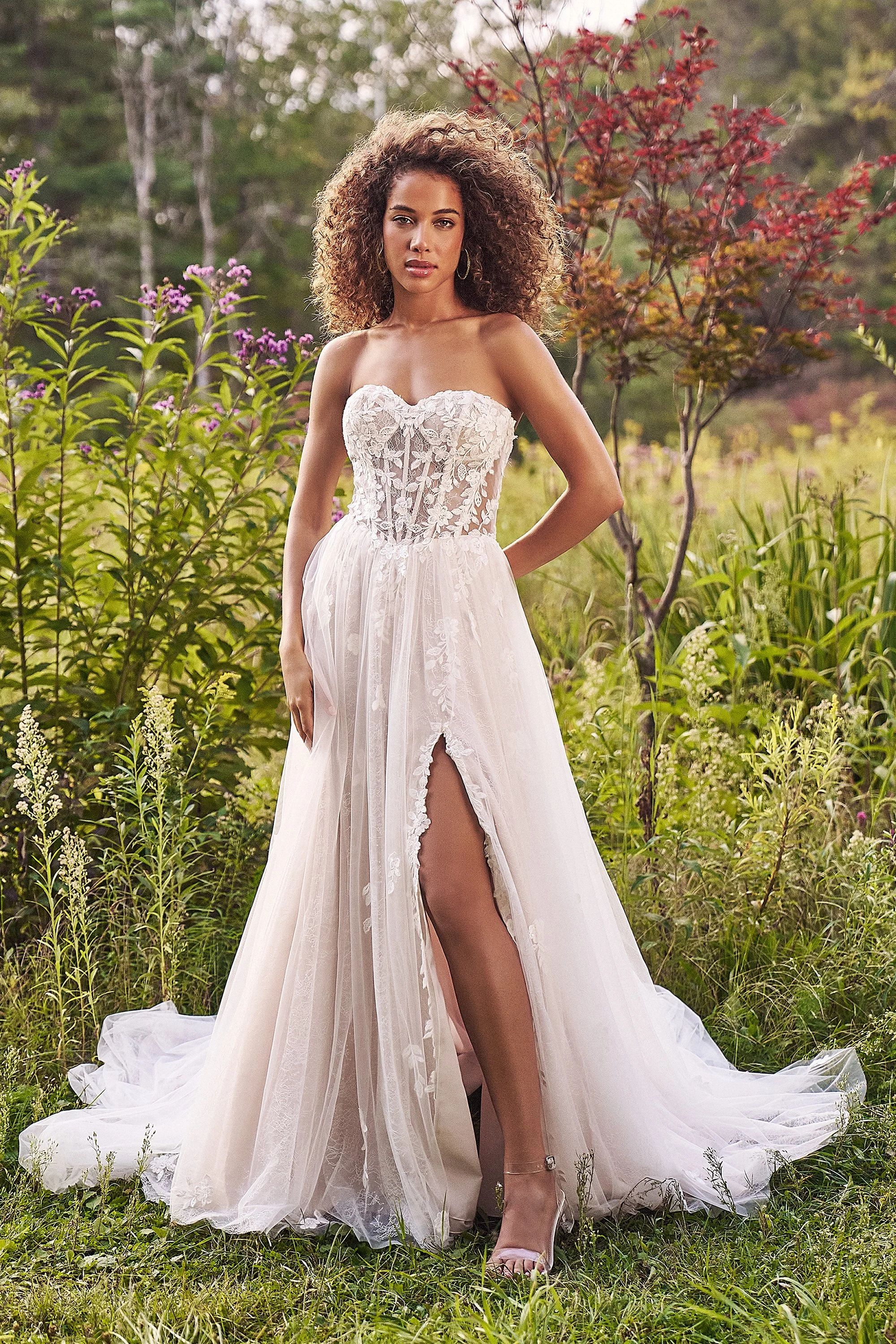 Lillian West wedding gown with lace layers and a slit in the skirt with a sheer lace bodice.